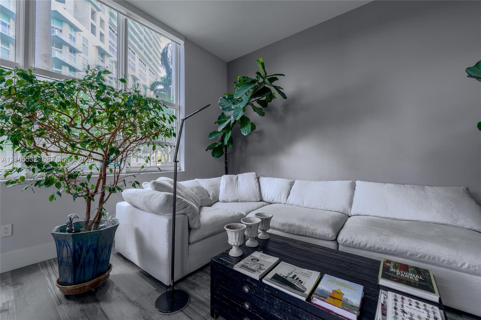 Floor-to-ceiling windows featuring expansive glass panels and wood-finish flooring