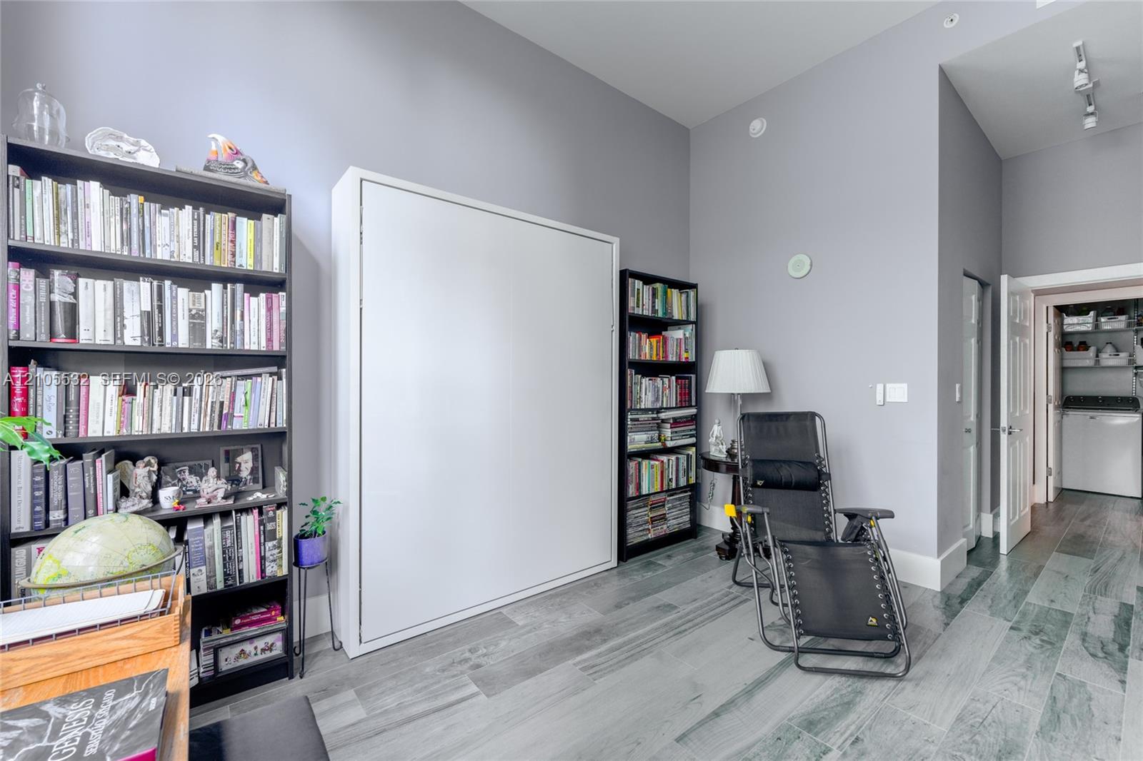 High ceilings, wood-finish flooring, and built-in wall cabinetry