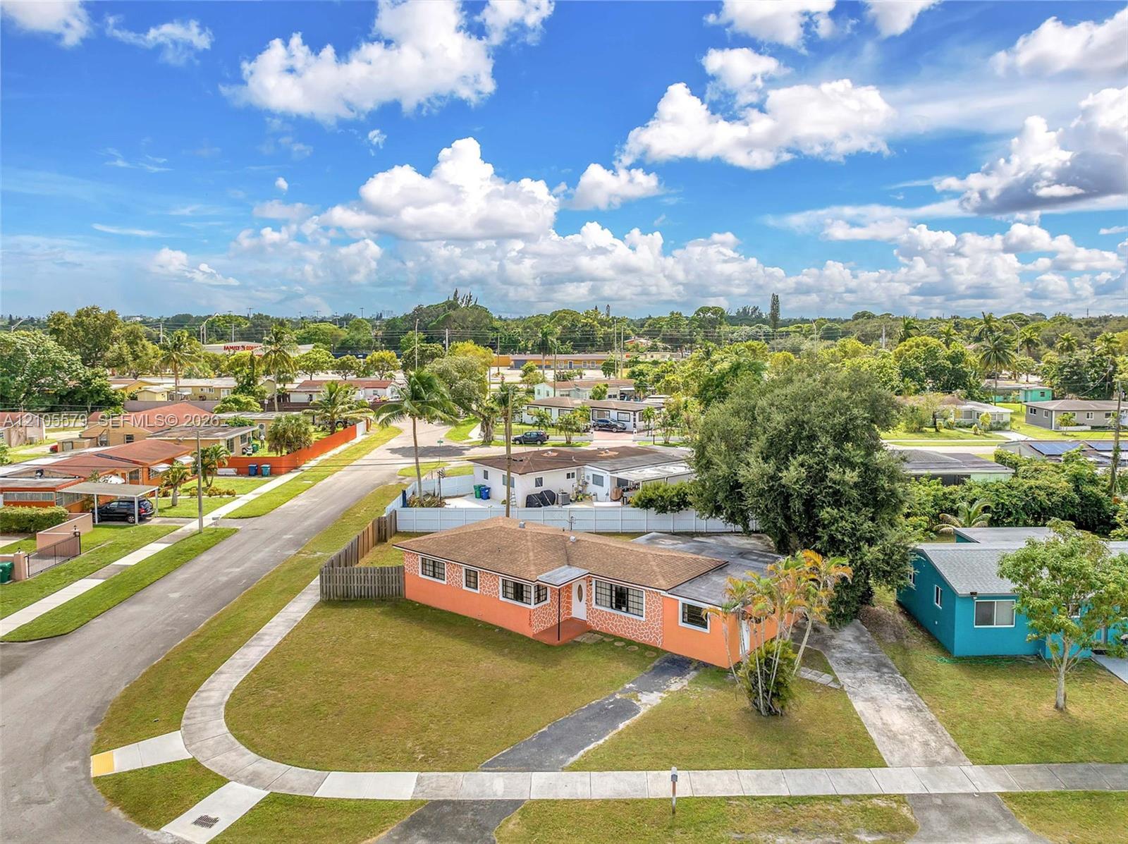 Single-story residence featuring a hipped roof, brick-veneer exterior, concrete driveway, and mature landscaping Single-story residence featuring a hipped roof, brick-veneer exterior, concrete driveway, and mature landscaping