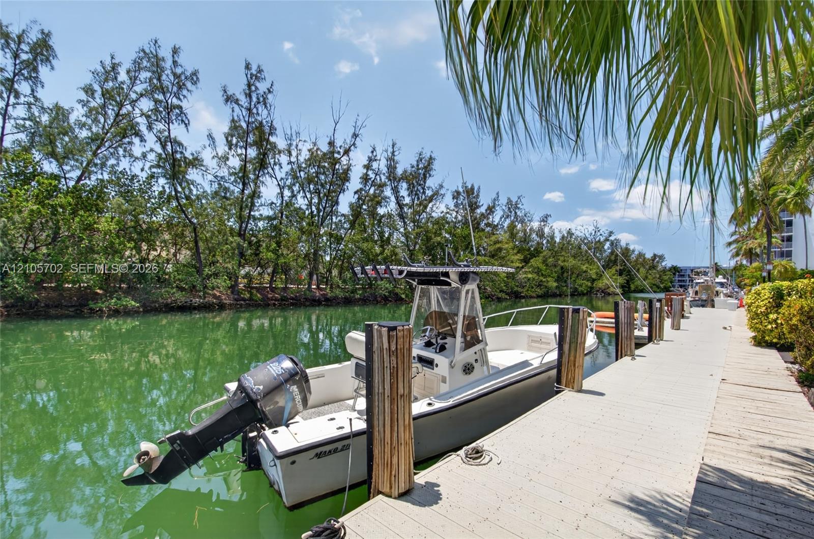 Private deep-water dock featuring integrated wood pilings and direct canal access