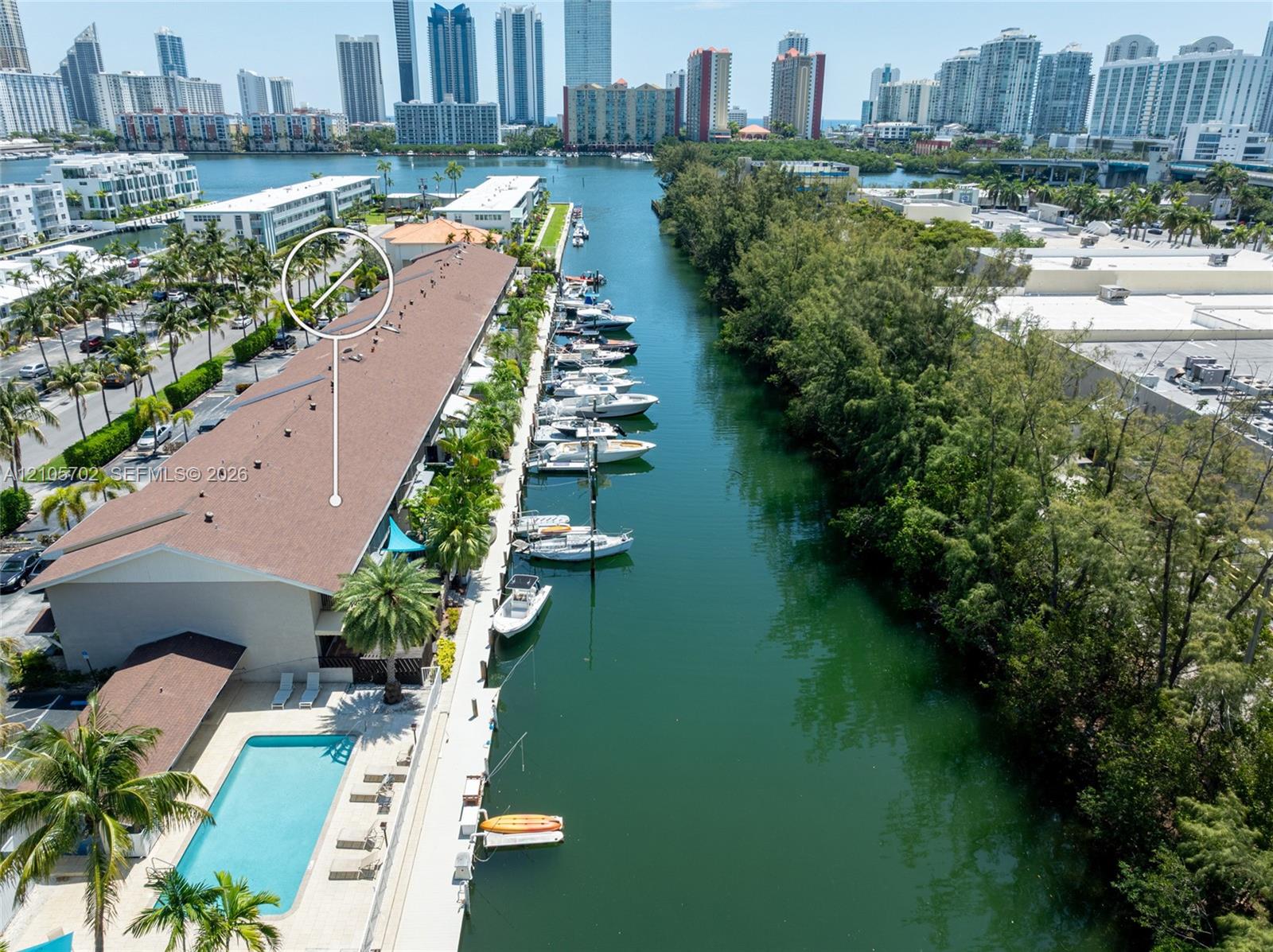Waterfront property featuring a canal-side dock, rectangular swimming pool, and concrete paved pool deck Waterfront property featuring a canal-side dock, rectangular swimming pool, and concrete paved pool deck