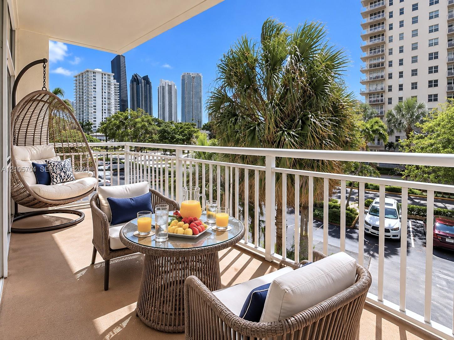 Private covered balcony featuring white metal railings and concrete flooring Private covered balcony featuring white metal railings and concrete flooring