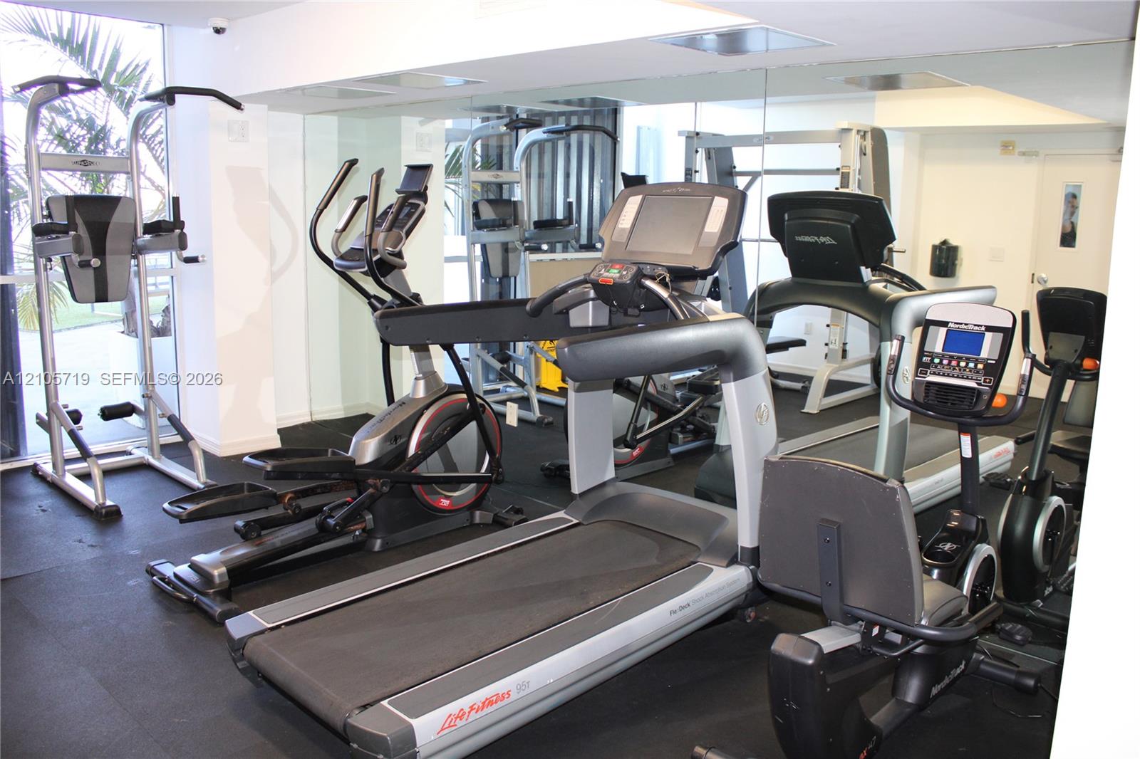Fitness facility featuring full-wall mirrors and high-impact rubber flooring
