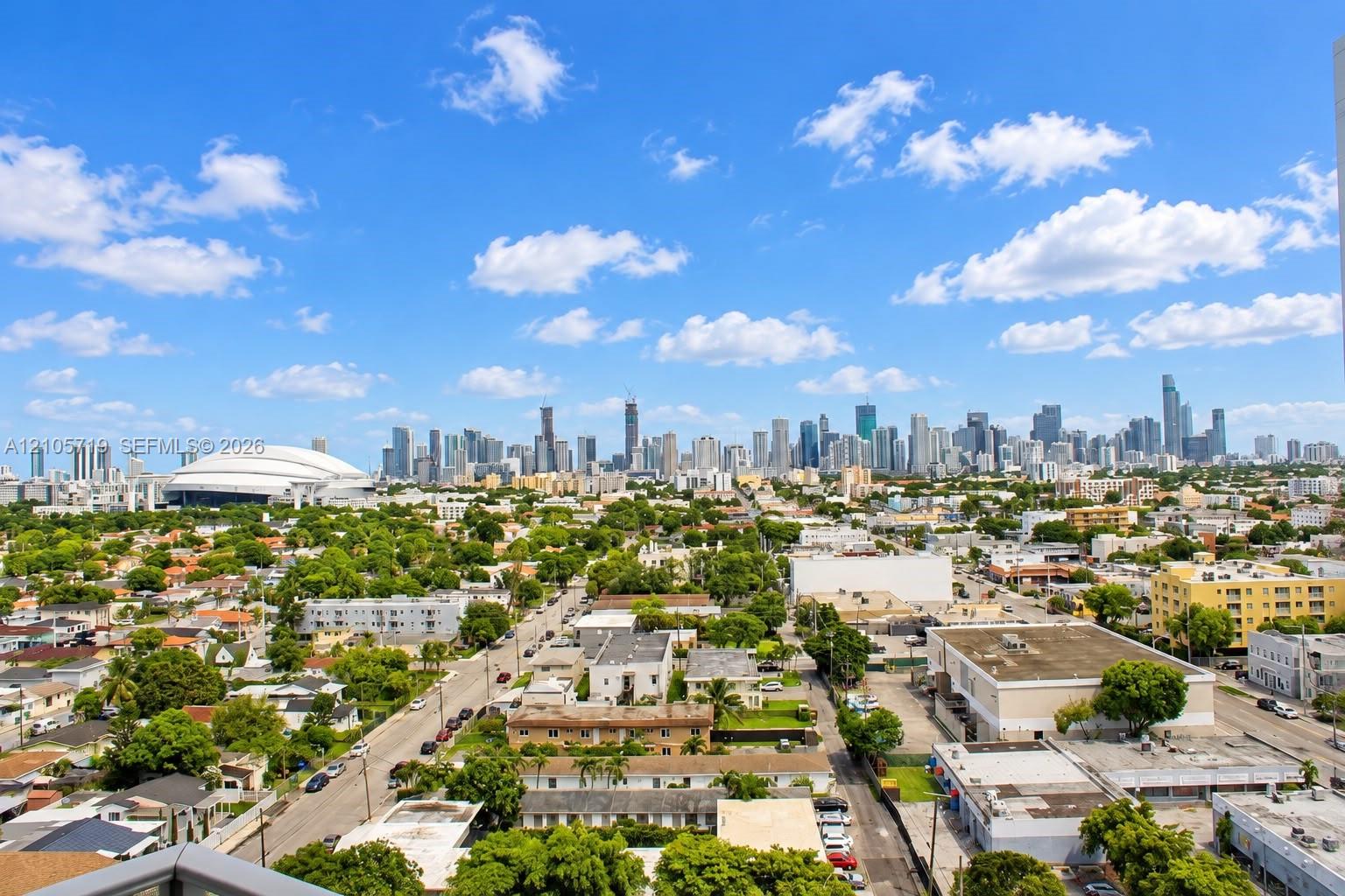 Elevated perspective showcasing an expansive urban skyline and a prominent domed stadium