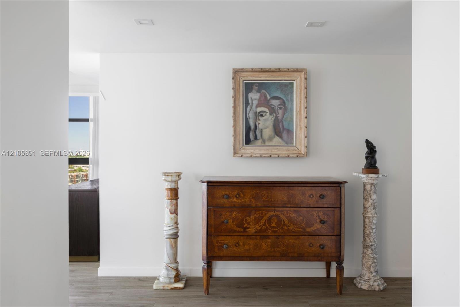 Neutral-toned walls and wood-finish flooring with recessed ceiling lighting