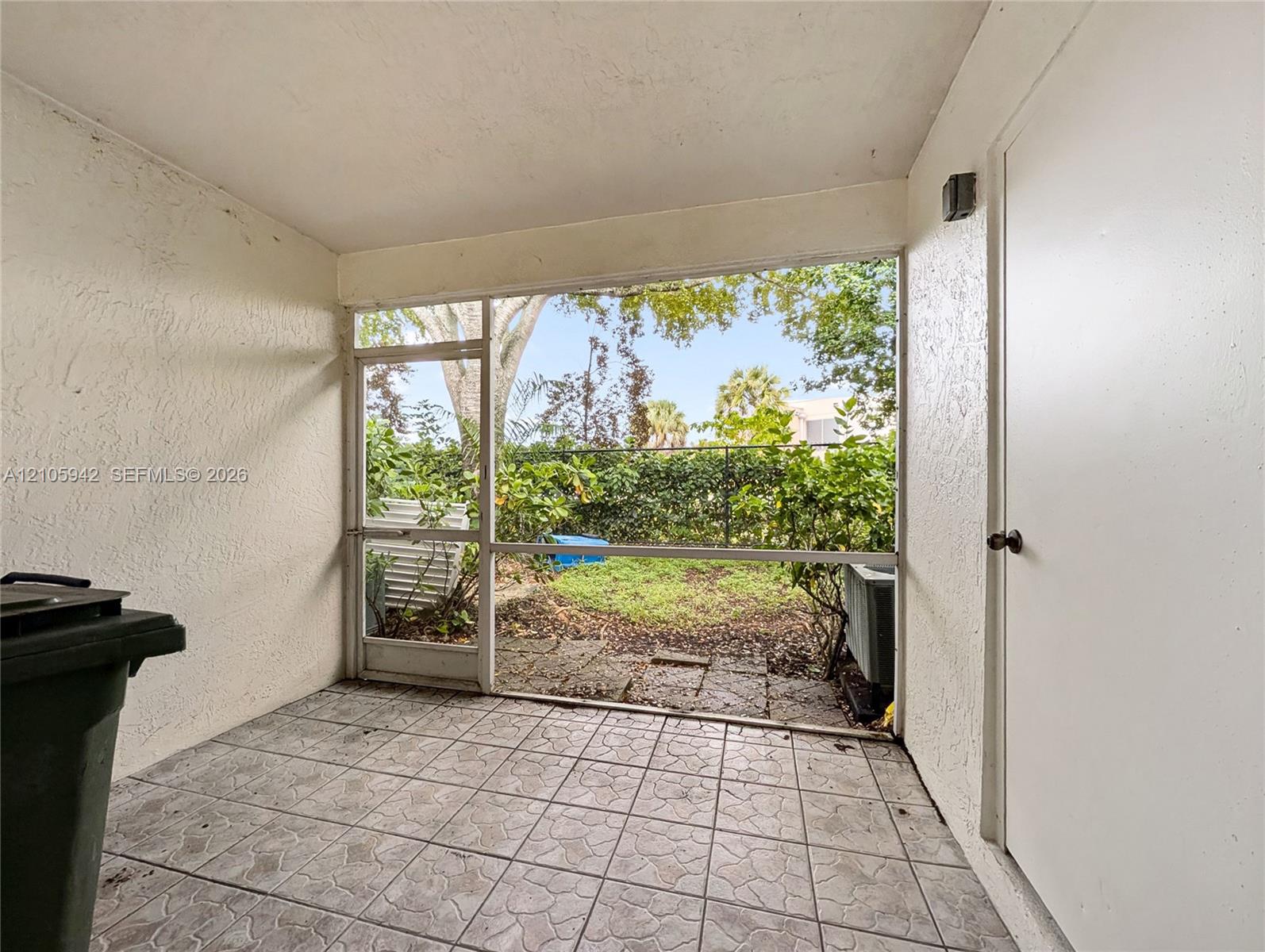 Screened-in porch featuring tiled flooring