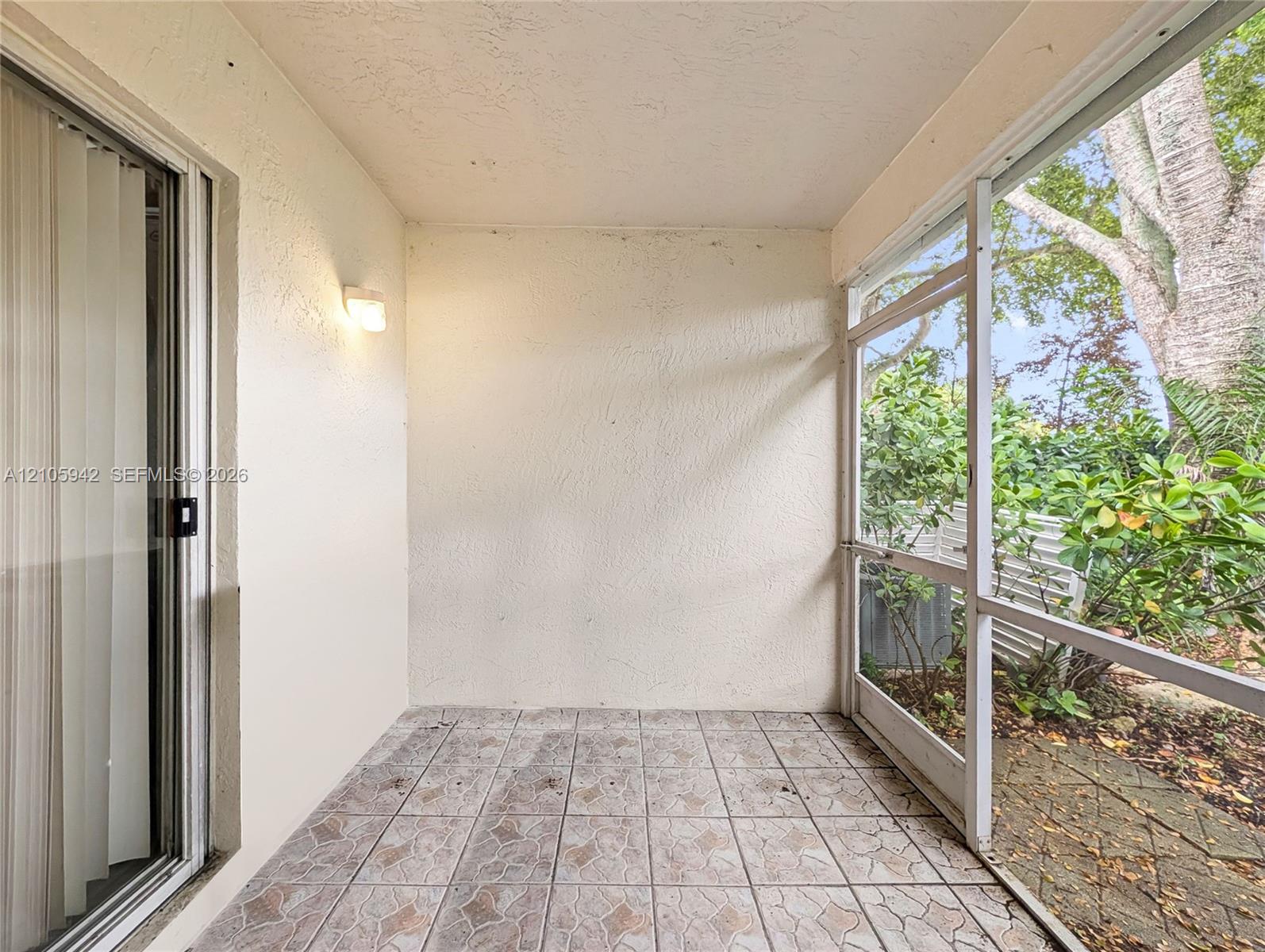 Screened-in porch featuring tiled flooring