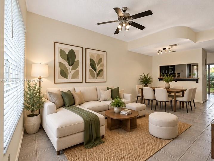 Staged-living ceramic floor tile, vaulted ceilings, a ceiling fan with integrated lighting