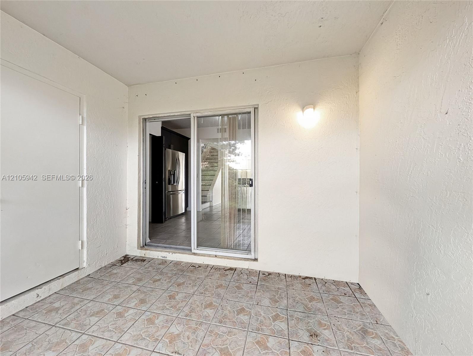Screened-in porch featuring tiled flooring