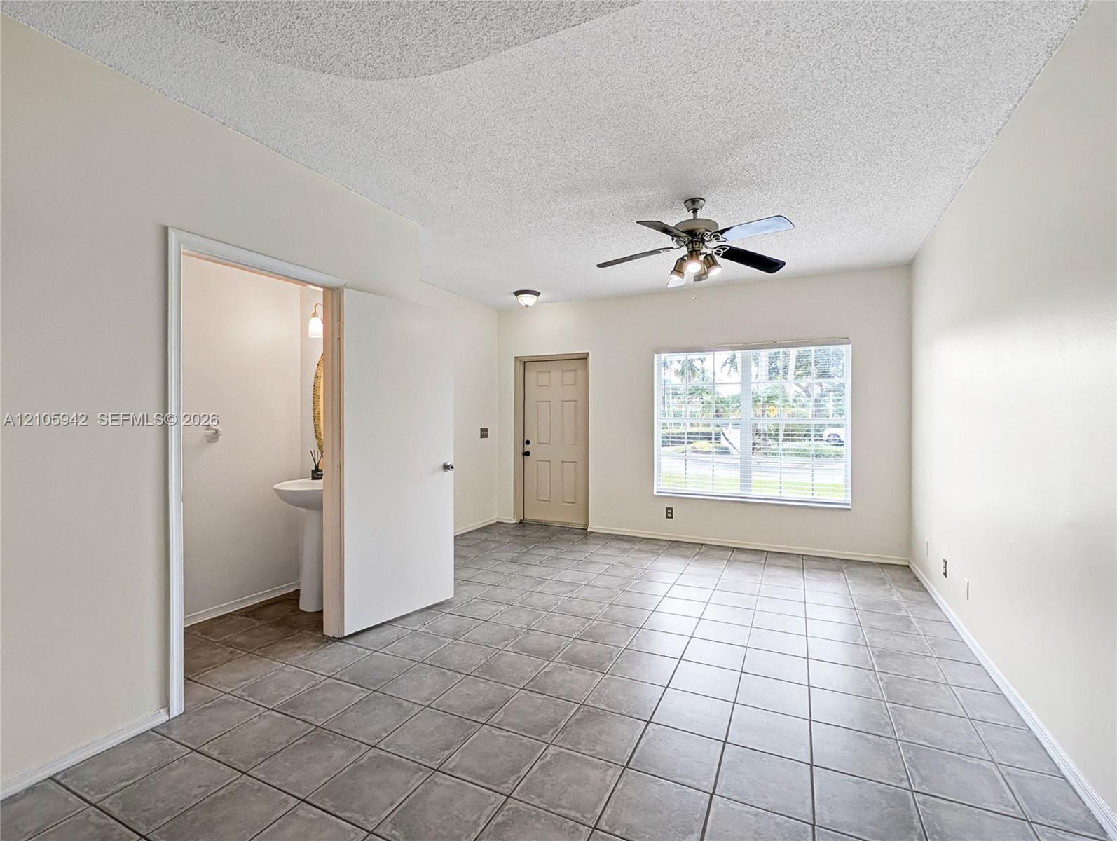 living ceramic floor tile, vaulted ceilings, a ceiling fan with integrated lighting