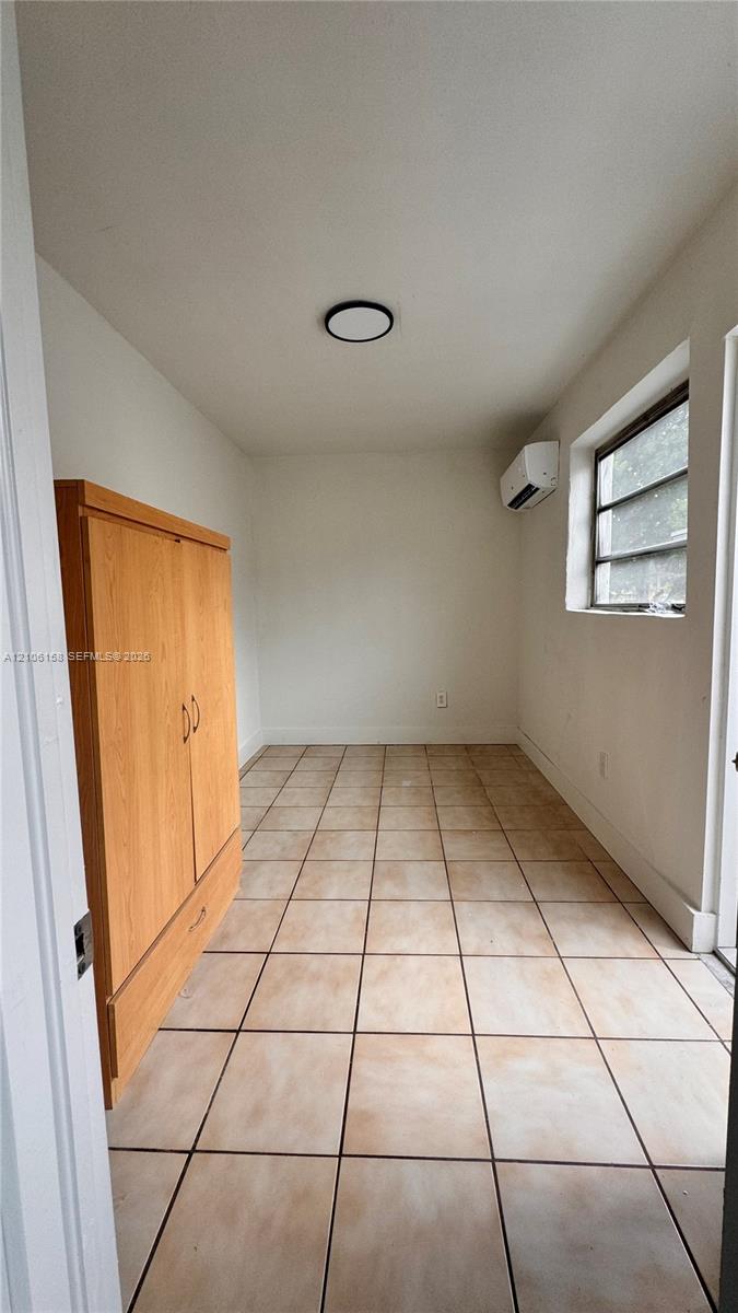 Square ceramic floor tiling, wall-mounted ductless air conditioning unit, recessed ceiling lighting, and horizontal window Square ceramic floor tiling, wall-mounted ductless air conditioning unit, recessed ceiling lighting, and horizontal window