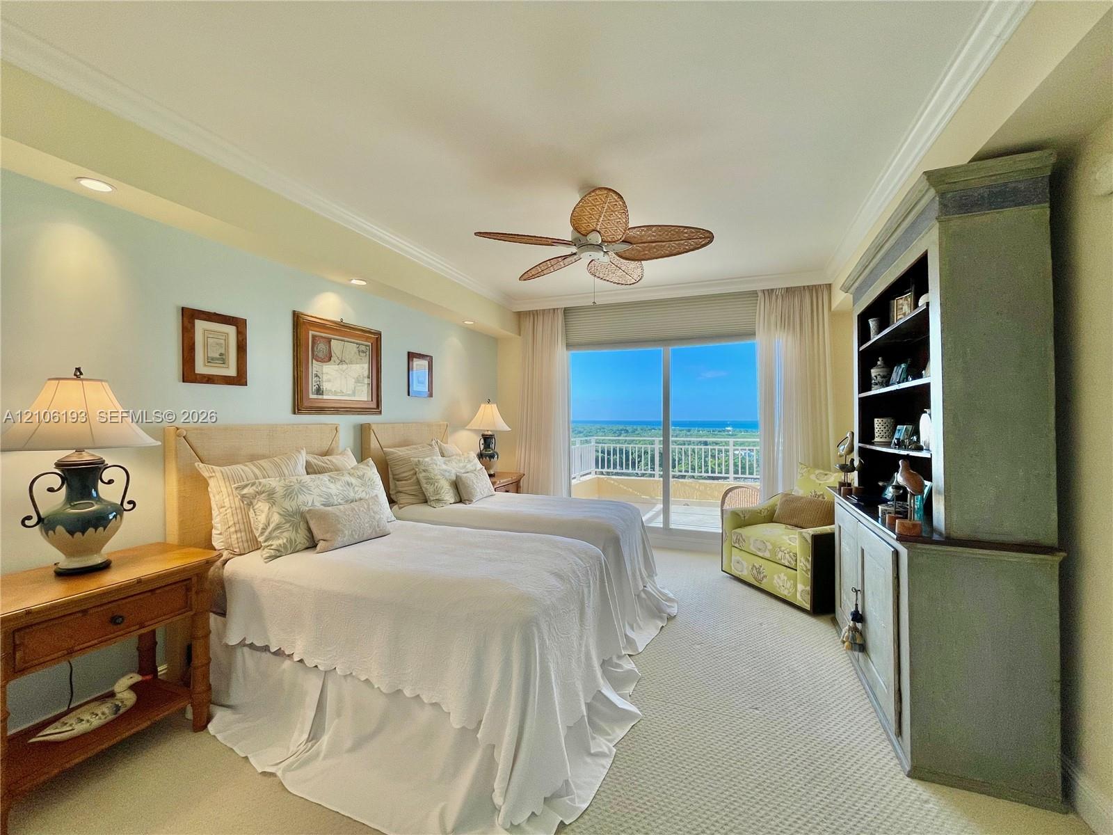 Bedroom featuring crown molding, recessed lighting, a ceiling fan with woven blades, built-in cabinetry, and sliding glass doors with direct access to a balcony