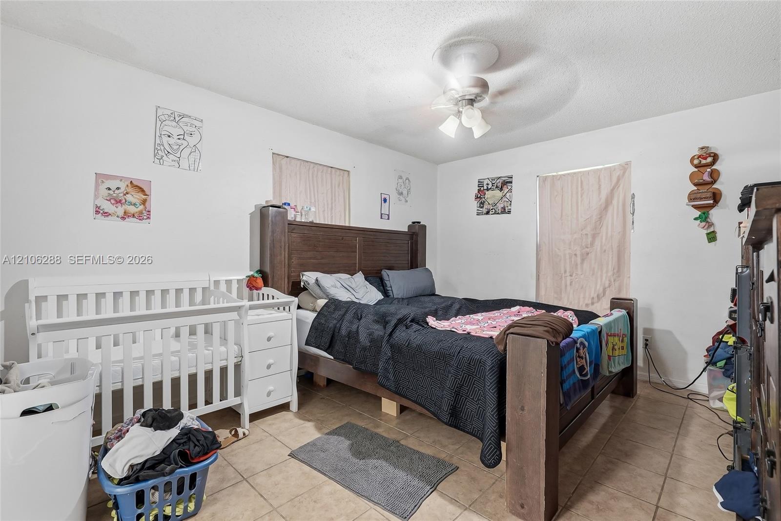 Ceramic tile flooring, central ceiling fan with integrated lighting, and dual window placement