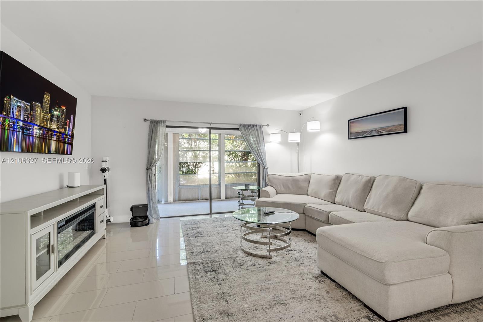 Neutral-toned ceramic tile flooring, sliding glass door with external screen enclosure, and recessed lighting