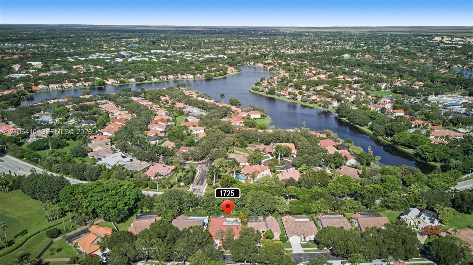 Aerial perspective of property featuring mature trees and expansive landscape