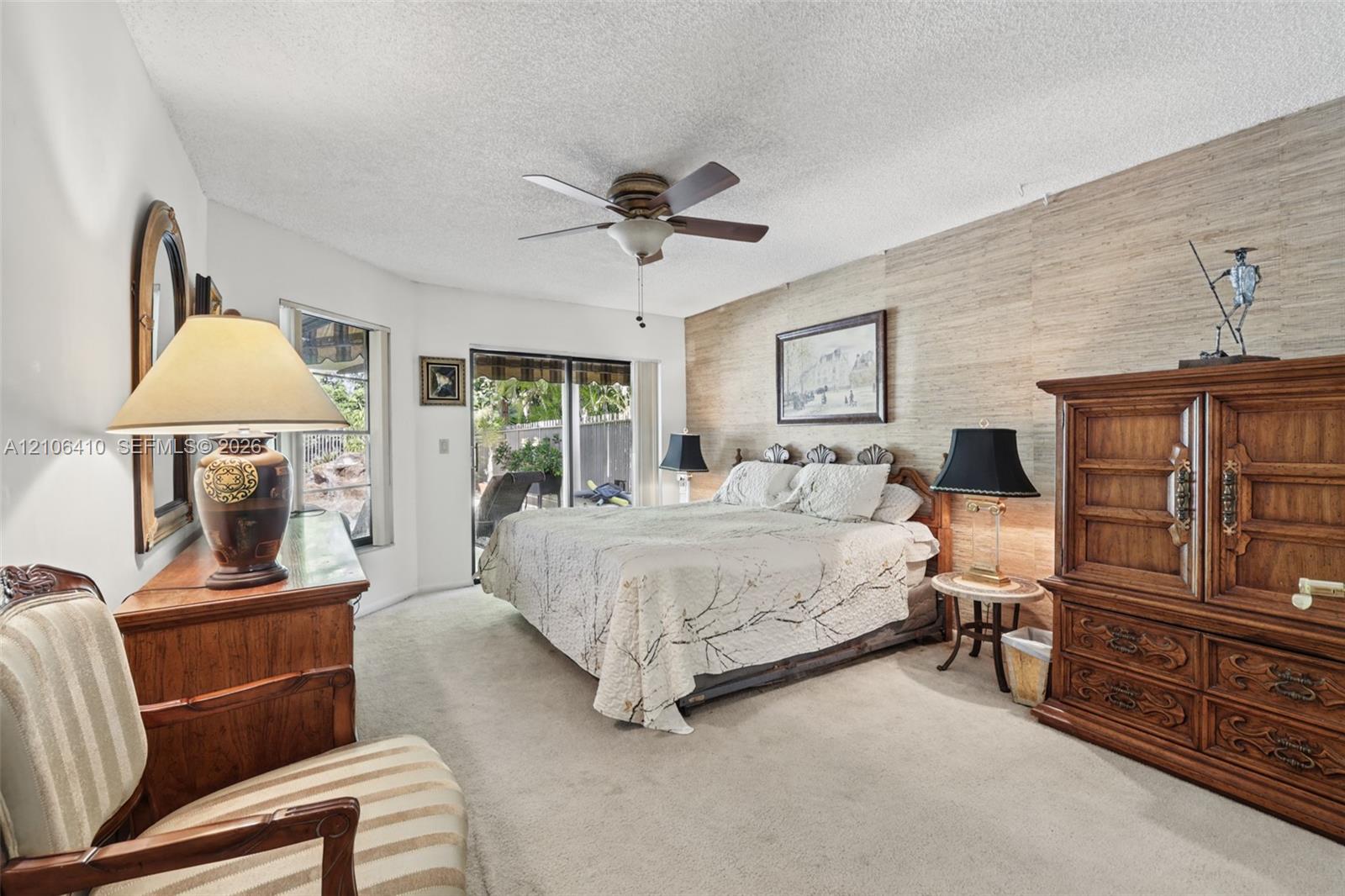 Textured wall covering, sliding glass door, ceiling fan, and window