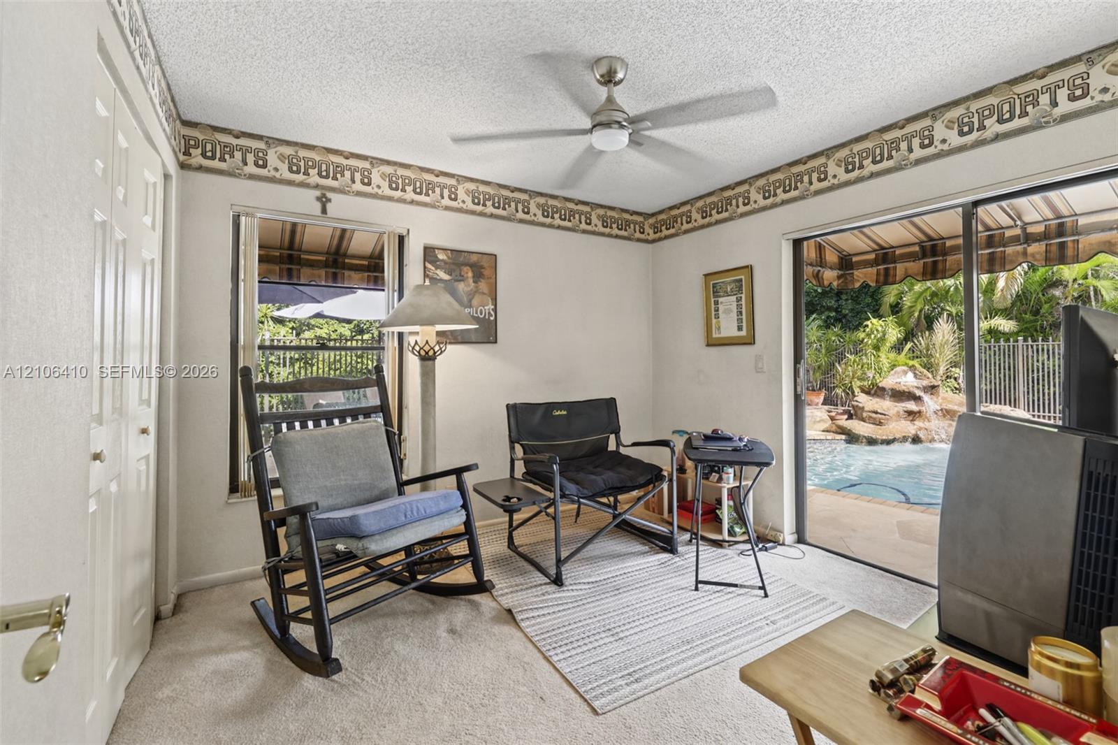 Interior space featuring a ceiling fan, sliding glass door, and dual-panel closet door