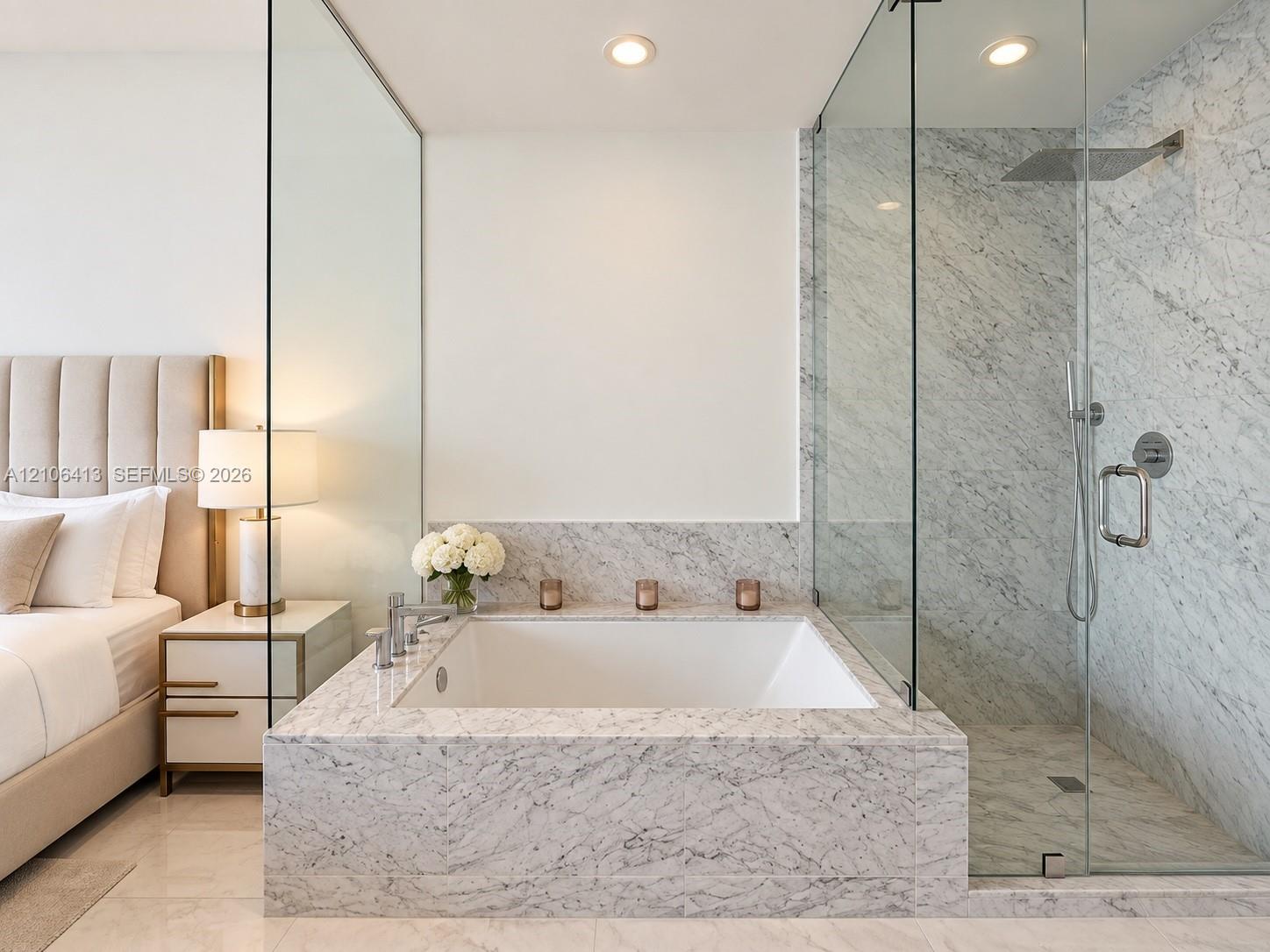 Soaking tub with stone surround, glass-enclosed walk-in shower with rain showerhead, and recessed lighting