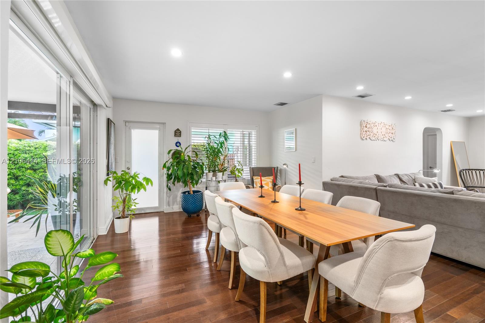 Interior space featuring wood-finish flooring, recessed lighting, expansive sliding glass doors, and a glass-paneled exterior door