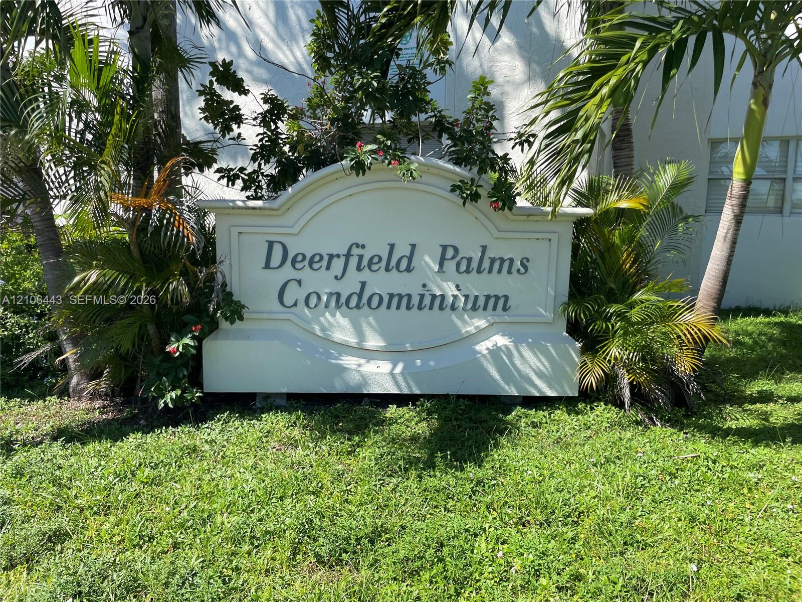 Custom-built masonry monument sign featuring embossed lettering and professional landscape planting