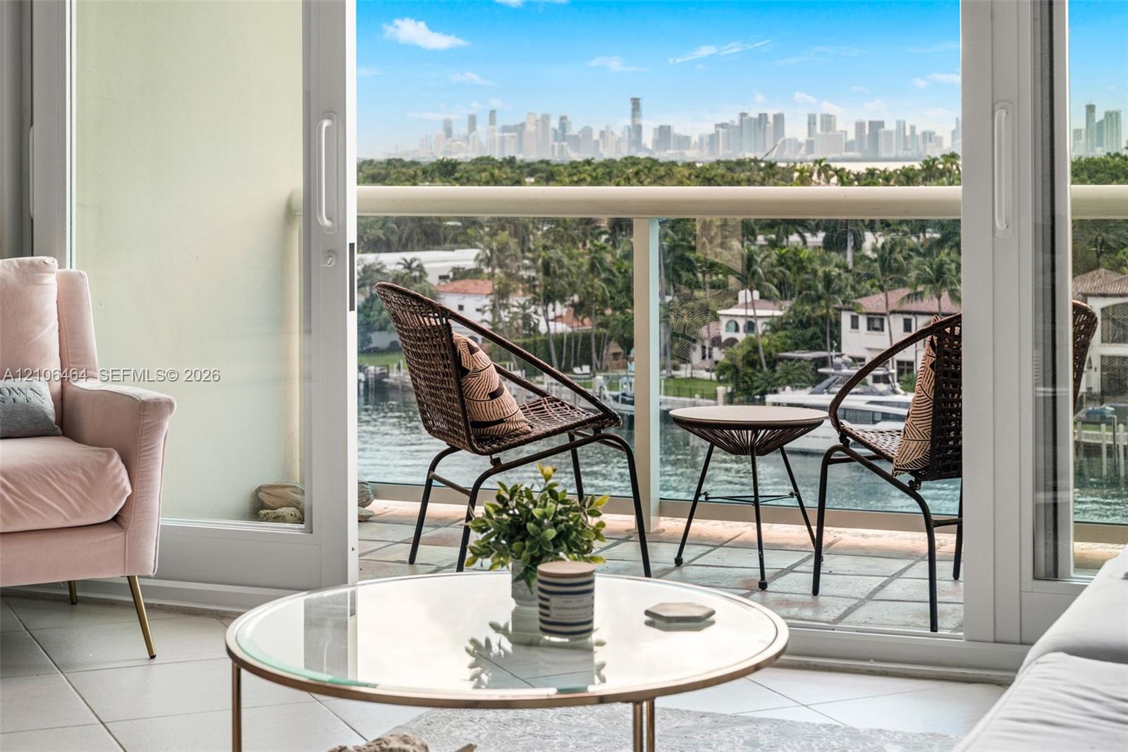 Balcony featuring glass railings, tile flooring, and direct exterior access via sliding glass doors