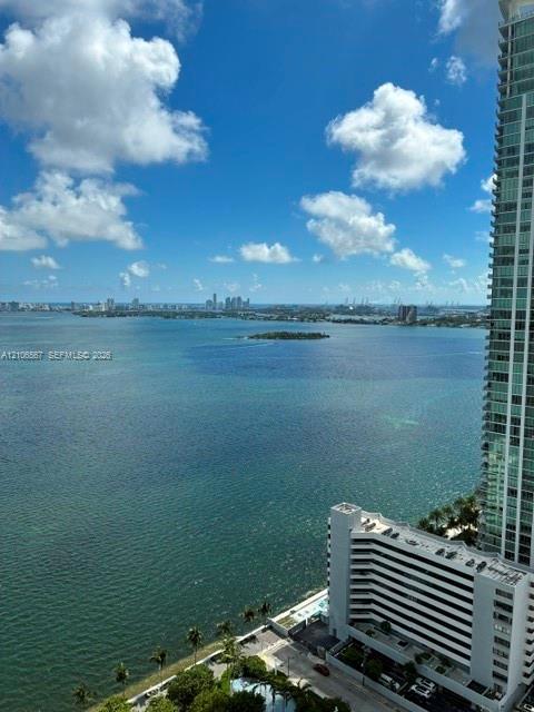High-rise perspective featuring panoramic coastal water exposure and a distant cityscape horizon