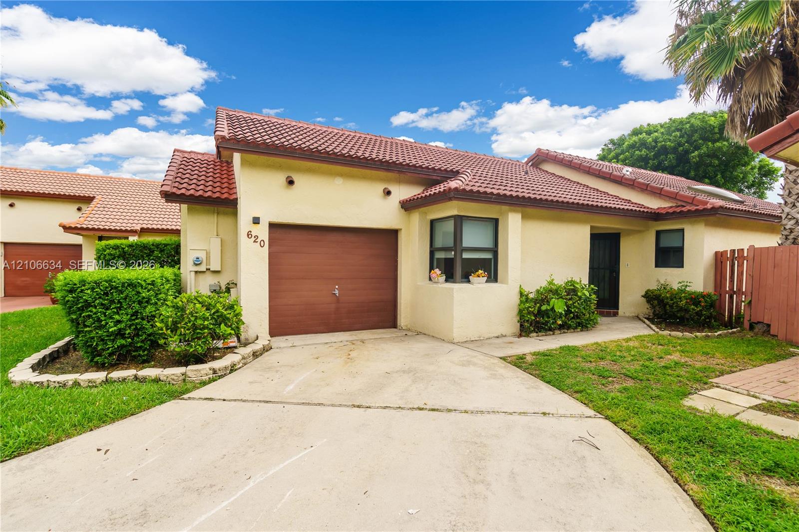 Front view of this beautiful waterfront residence single-car garage & driveway