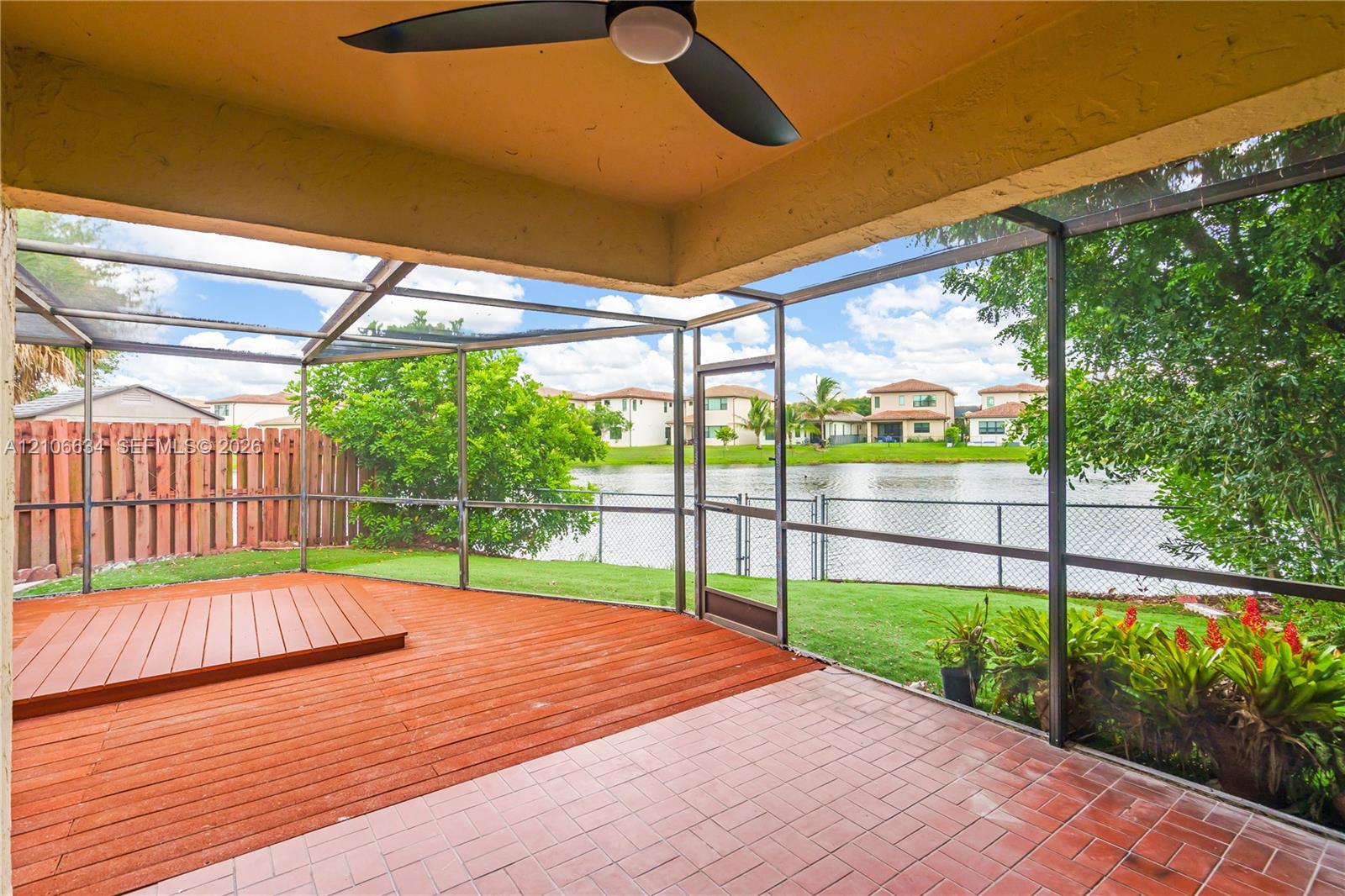 Screened patio includes a ceiling fan, and direct water exposure