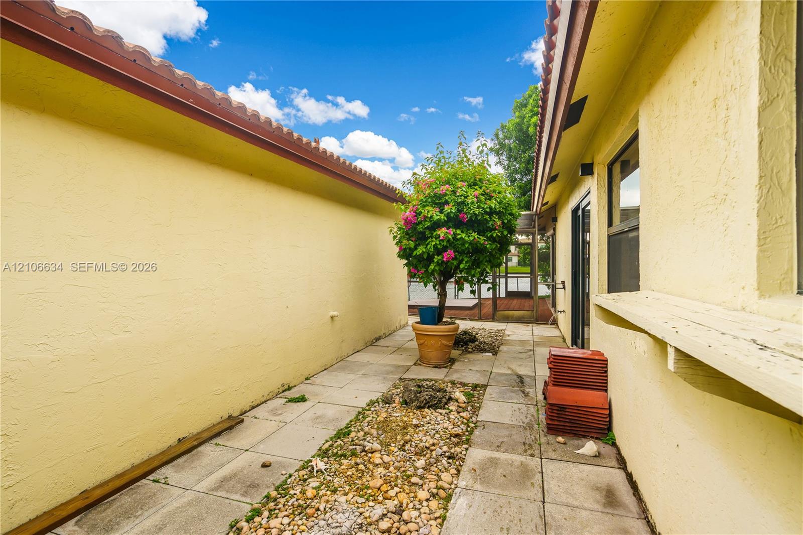 Exterior side yard entrance with paved walkway