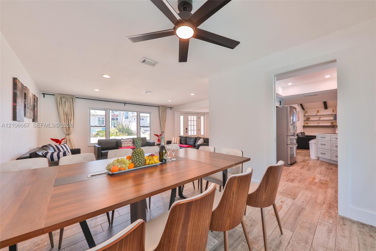 Open-concept interior featuring wood-finish flooring, recessed lighting, and a modern ceiling fan