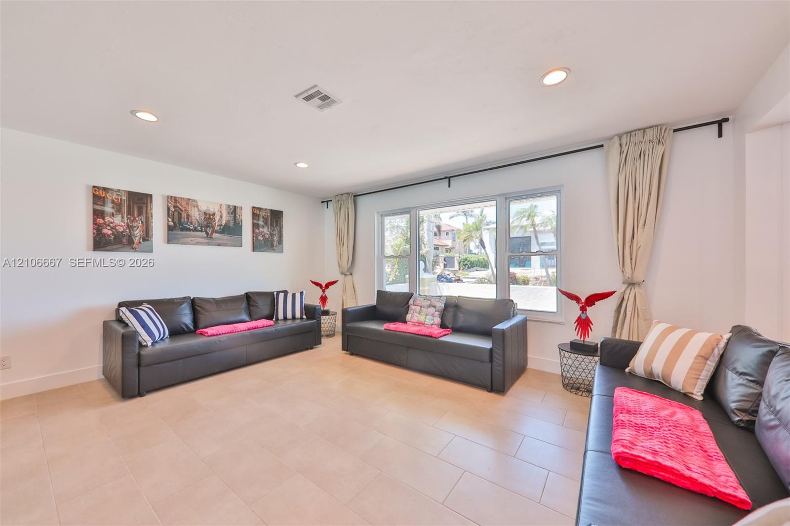 Neutral-toned ceramic tile flooring, large multi-pane window, and recessed ceiling lighting Neutral-toned ceramic tile flooring, large multi-pane window, and recessed ceiling lighting