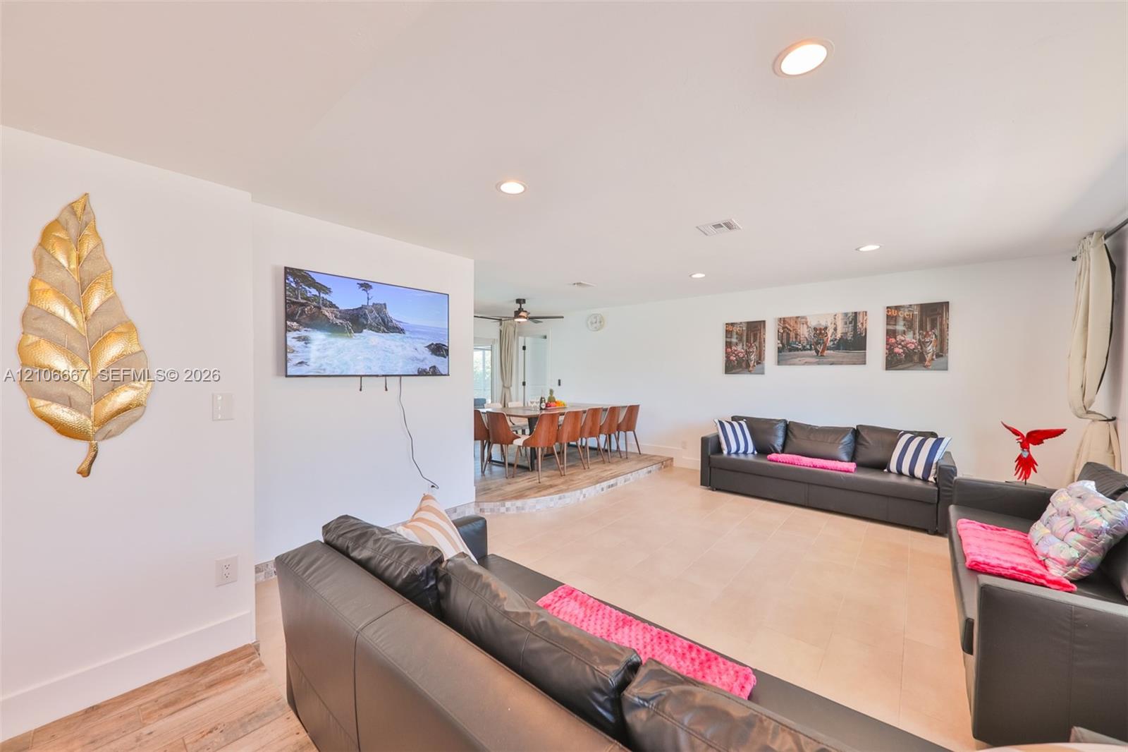 Open-concept living space featuring recessed lighting, ceramic tile flooring, and a raised platform area Open-concept living space featuring recessed lighting, ceramic tile flooring, and a raised platform area