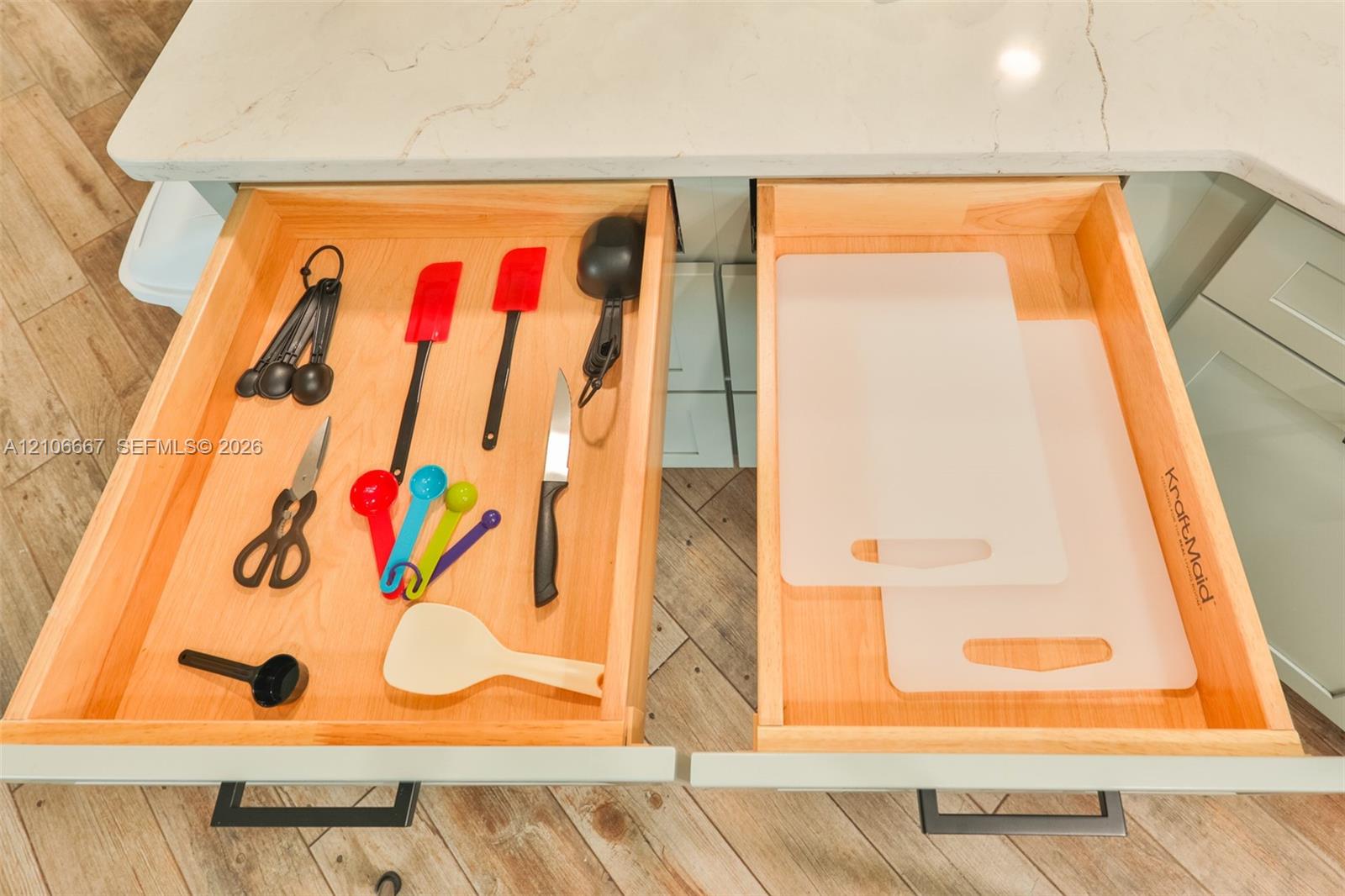 Custom wood-dovetail cabinetry drawers with stone countertops, undermount hardware, and integrated pulls