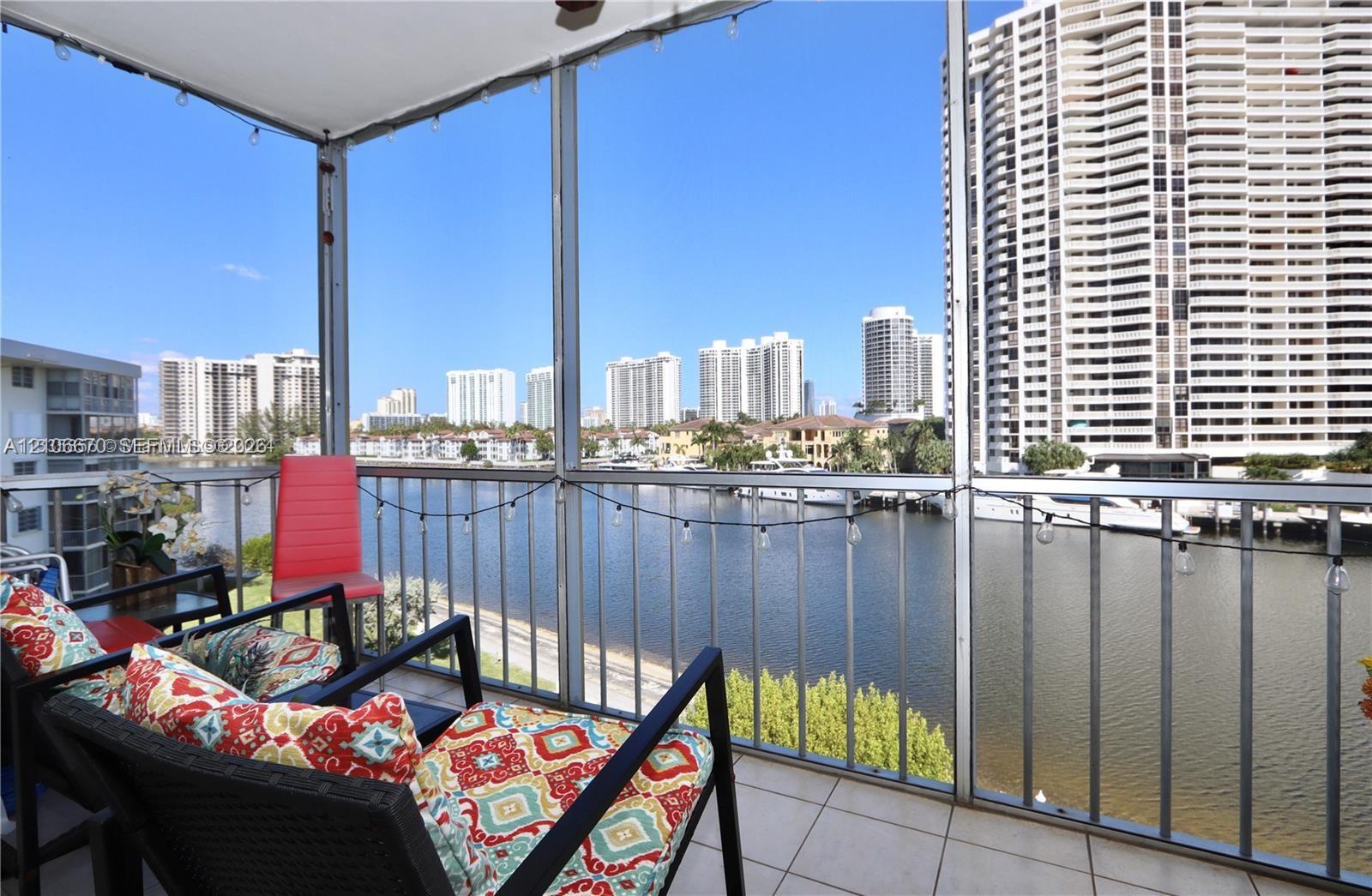 Screened-in balcony featuring tile flooring and metal railings overlooking the waterway Screened-in balcony featuring tile flooring and metal railings overlooking the waterway