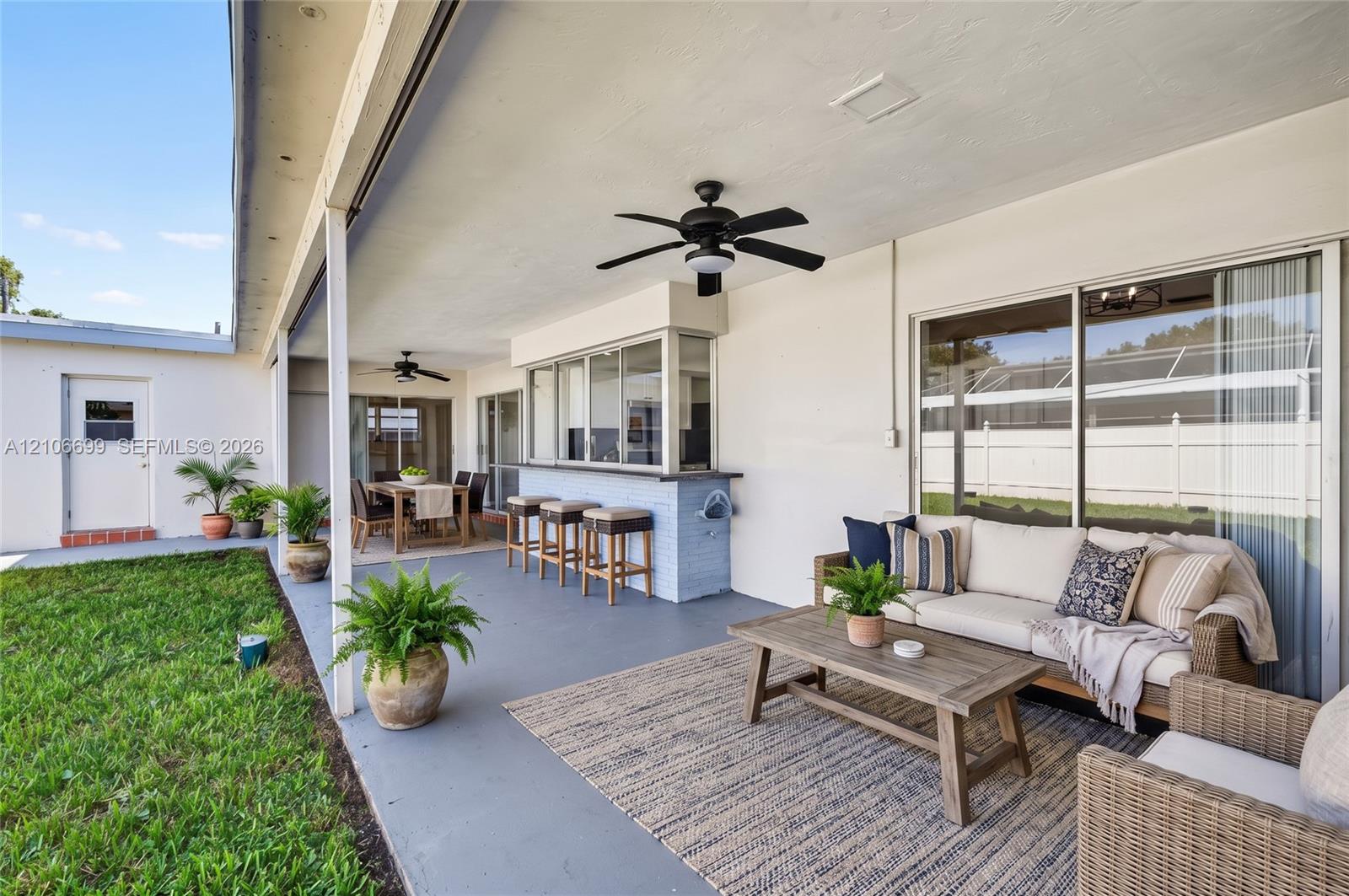 Backyard w/ covered patio & fans