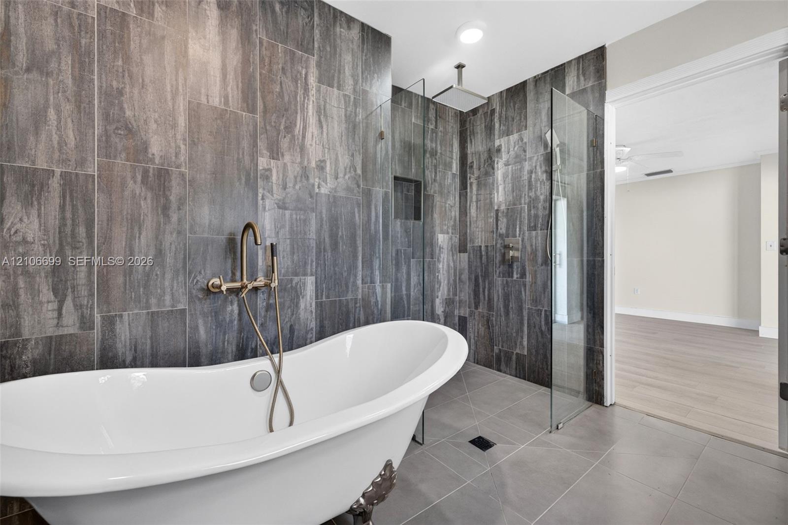 Primary bathroom w/ door to backyard. Separate tub & shower
