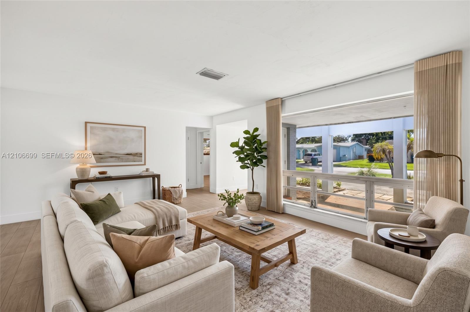 Light filled family room w/ large window overlooking front yard