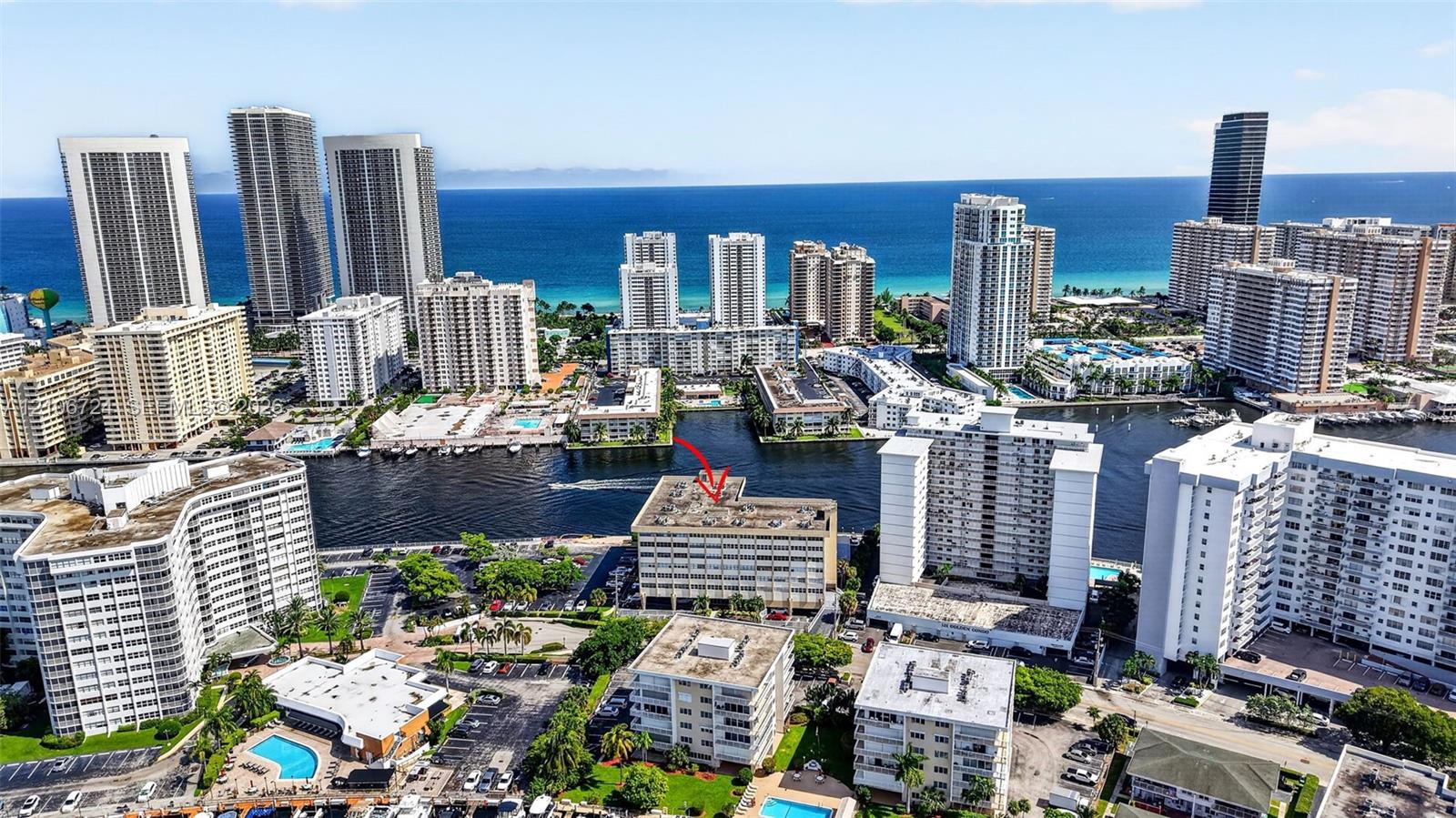Aerial perspective of the coastal cityscape featuring high-rise buildings, waterway access, and proximity to the oceanfront
