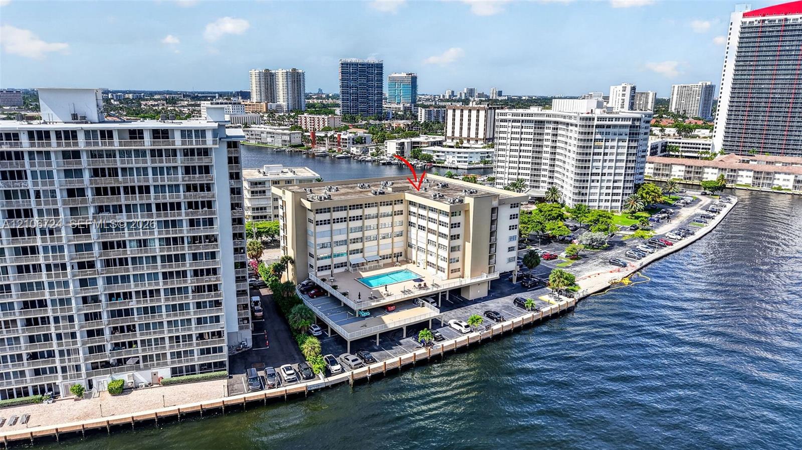 Mid-rise waterfront building featuring a rooftop swimming pool and direct bulkhead access