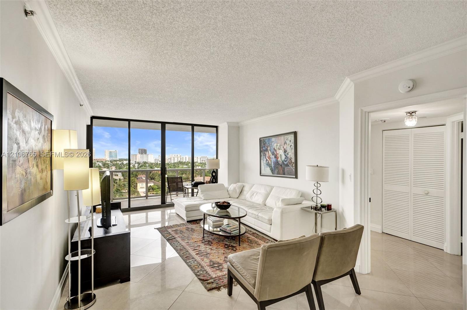 Floor-to-ceiling glass doors opening to a balcony. Floor-to-ceiling glass doors opening to a balcony.