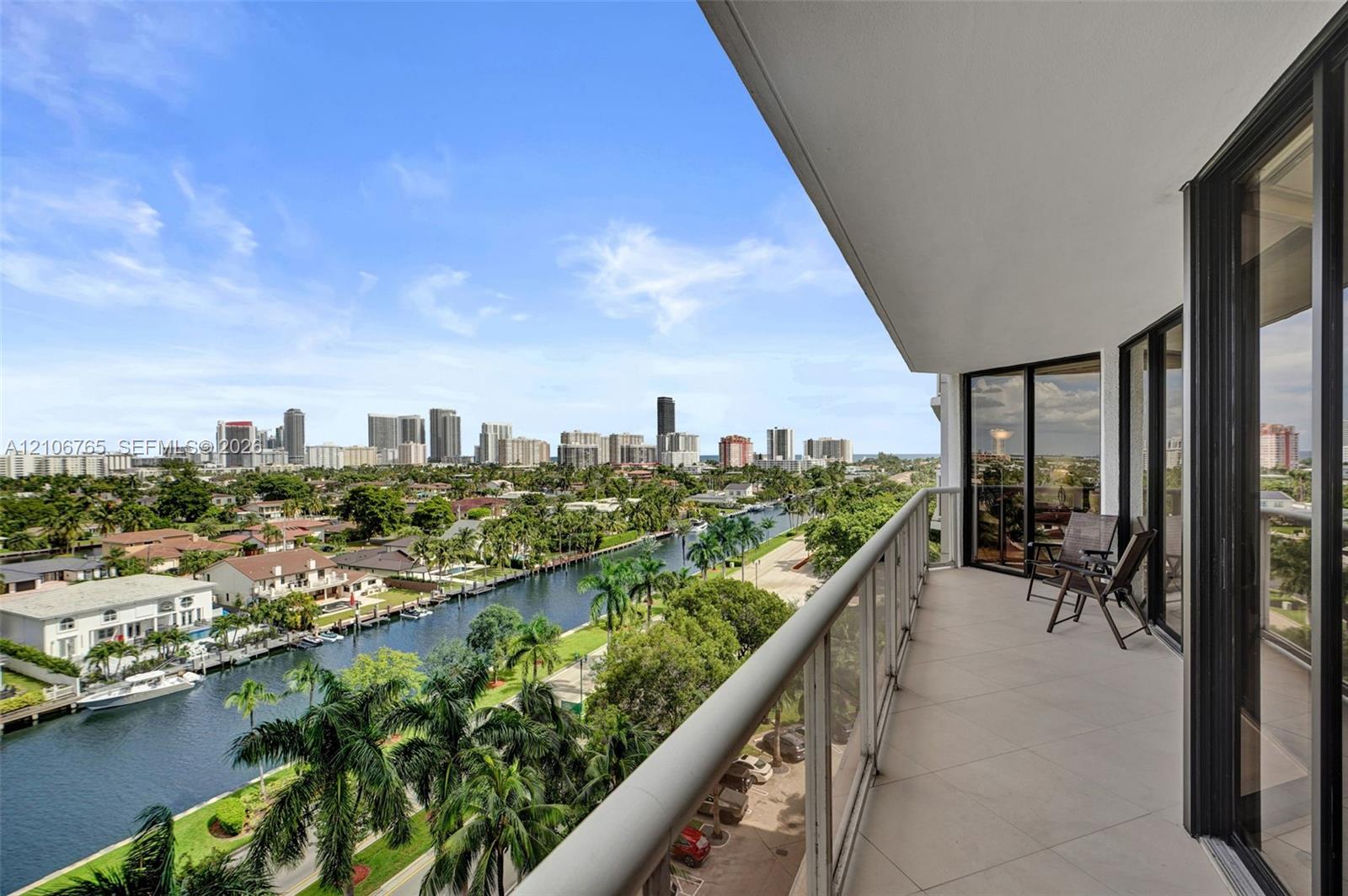 Covered balcony, overlooking the canal and urban skyline.
