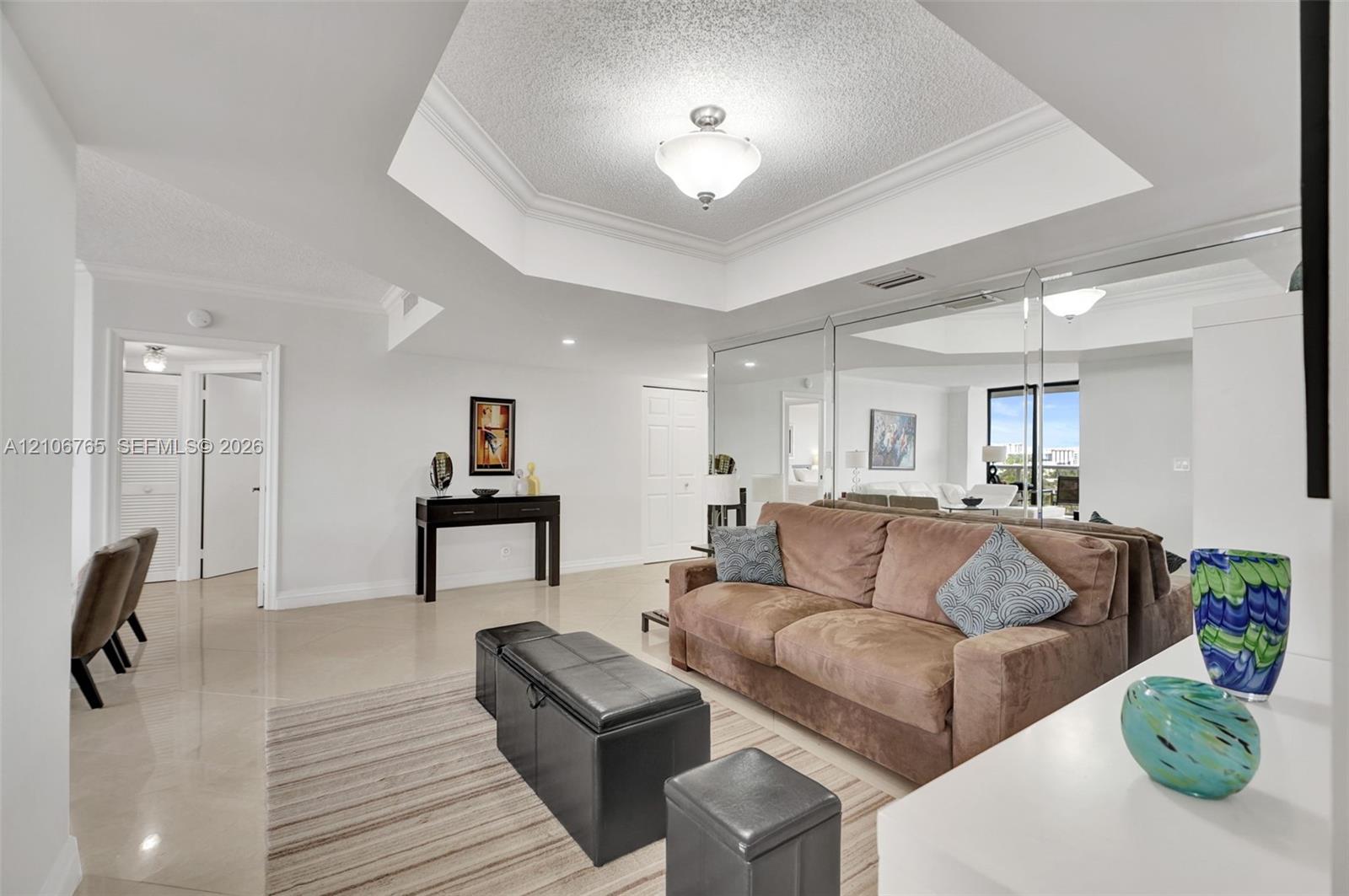 Dining room used as a den, octagonal tray ceiling with recessed lighting and neutral wall finishes, mirrored wall. Dining room used as a den, octagonal tray ceiling with recessed lighting and neutral wall finishes, mirrored wall.