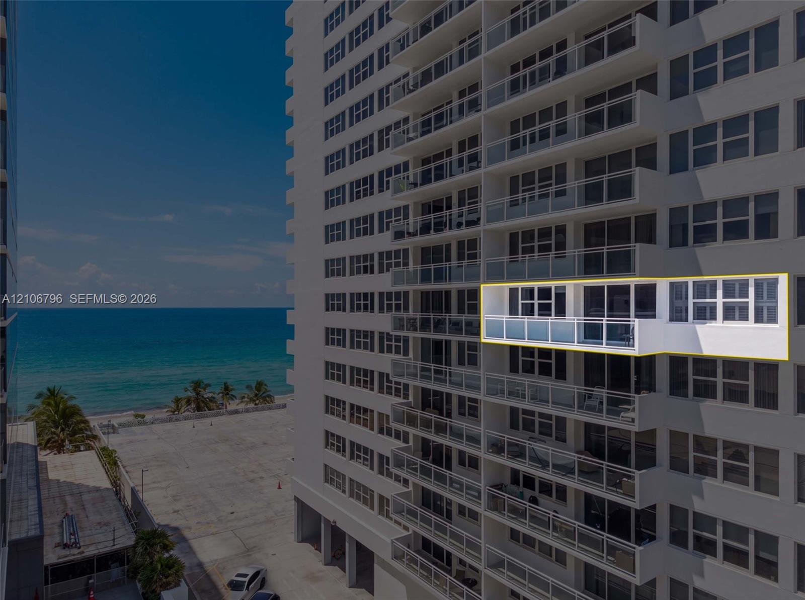 High-rise building exterior featuring glass balcony railings and sliding floor-to-ceiling windows