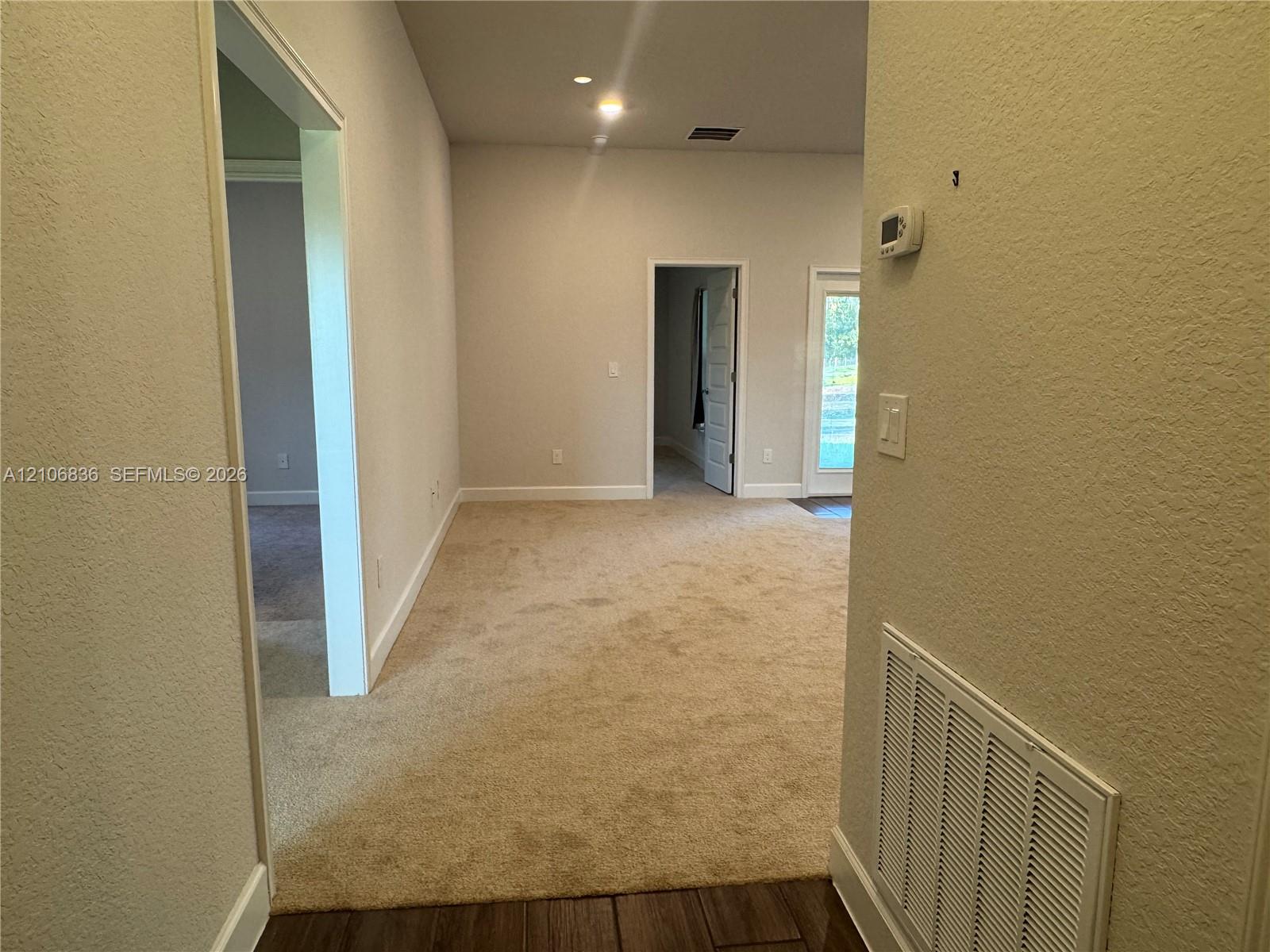 Neutral wall tones, carpeted flooring, recessed lighting, and interior passage doors Neutral wall tones, carpeted flooring, recessed lighting, and interior passage doors