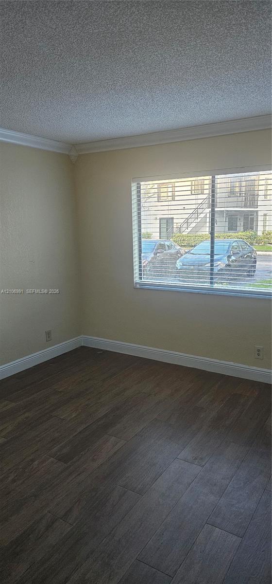 Interior space featuring wood-finish flooring, crown molding, and horizontal slat window blinds Interior space featuring wood-finish flooring, crown molding, and horizontal slat window blinds