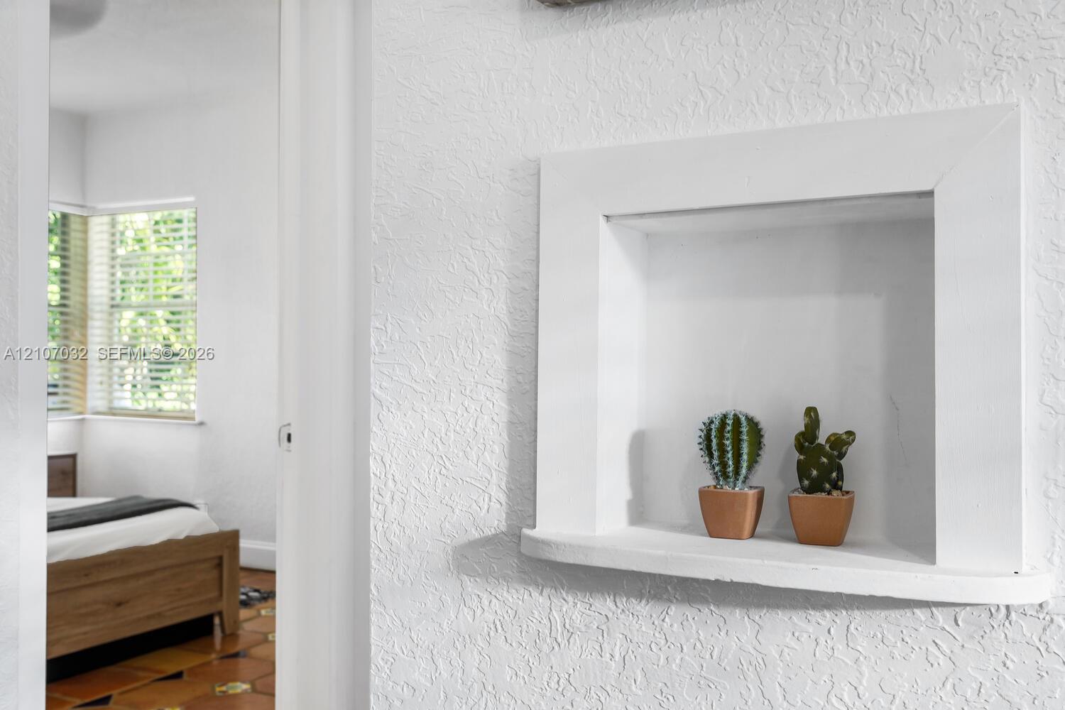Built-in wall niche with a curved shelf and textured wall finish