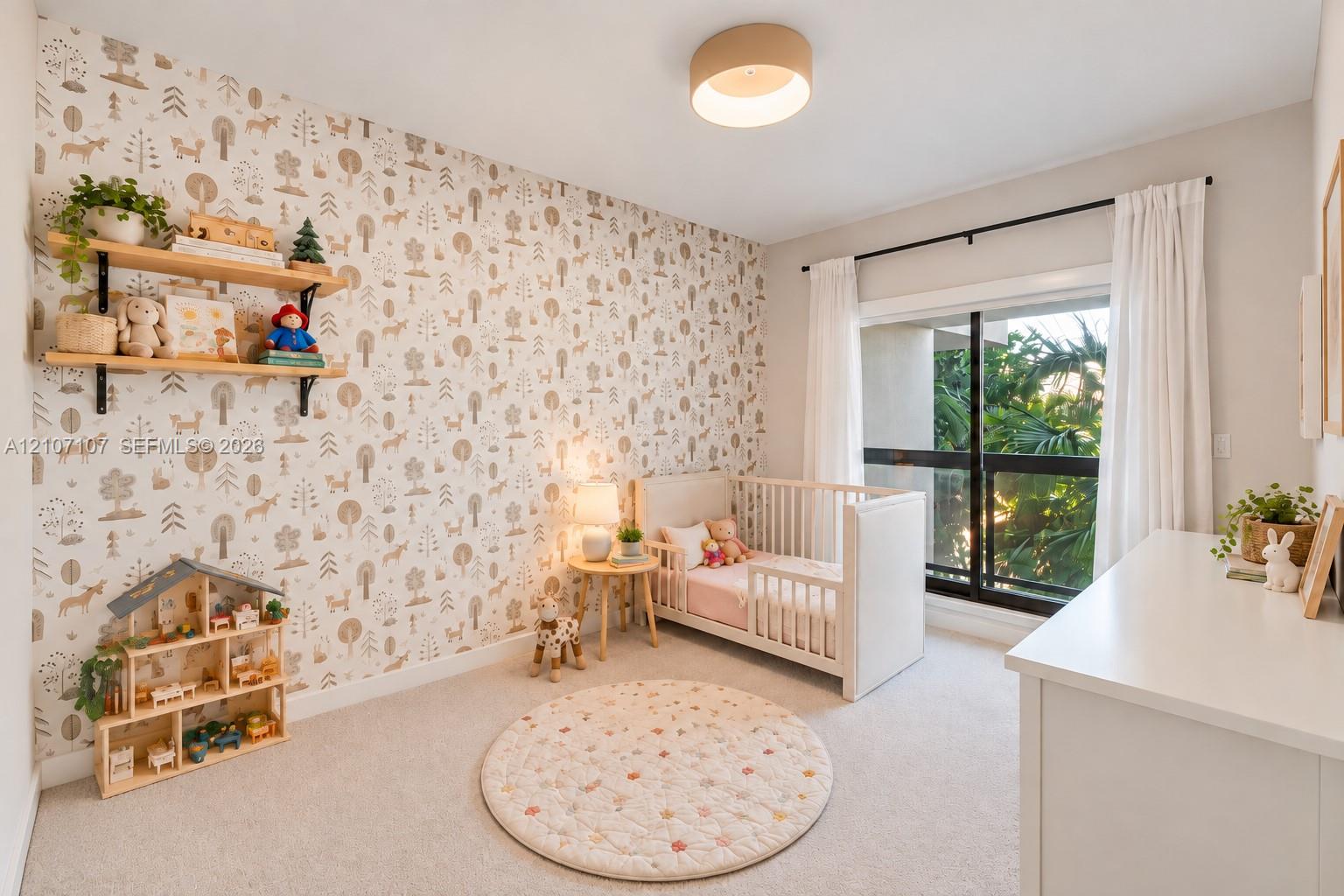 Room with patterned wallpaper, wall-mounted shelving, neutral carpeting, and a sliding glass door with a black frame