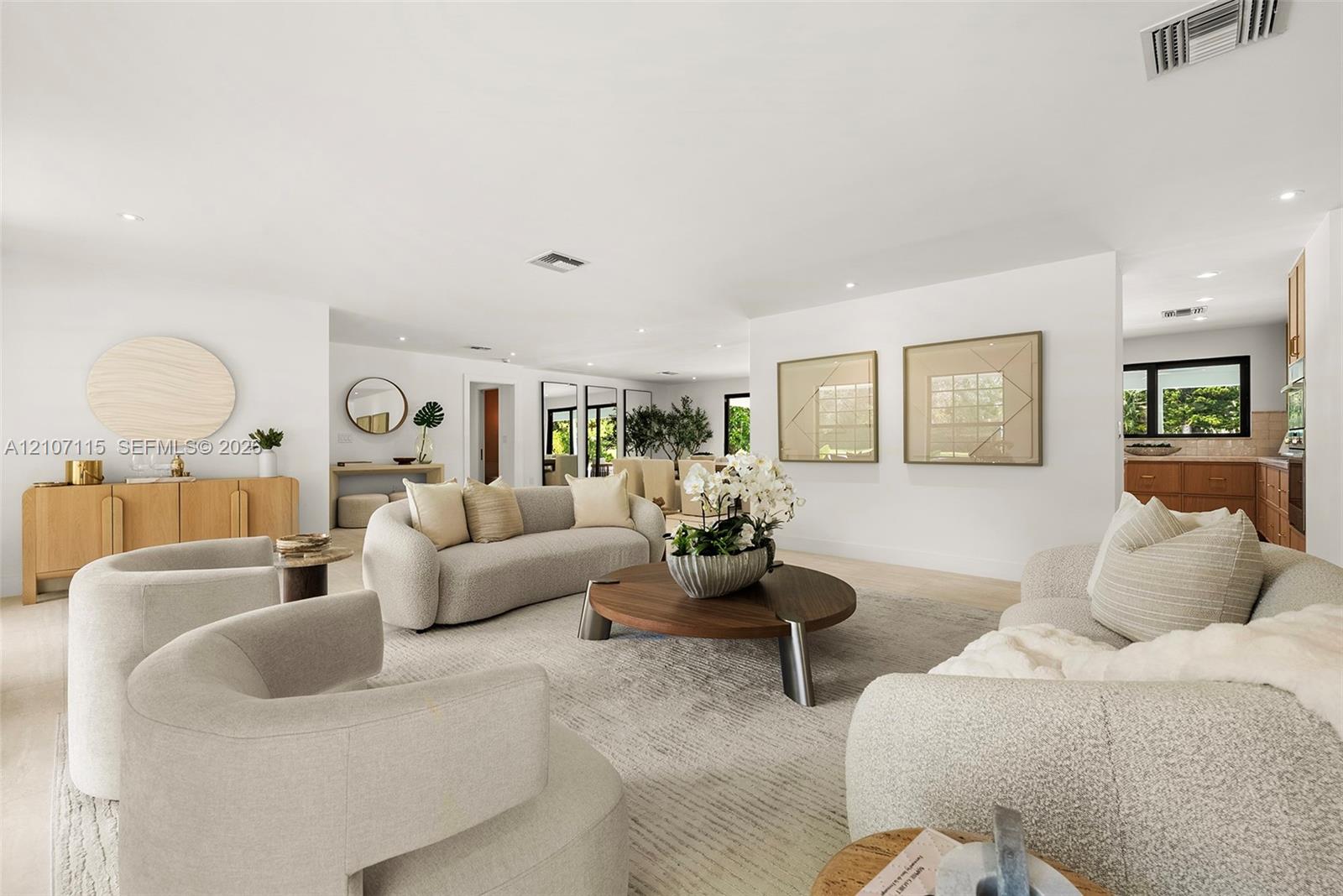 Open floor plan featuring recessed lighting, smooth white walls, light-toned flooring, and neutral finishes