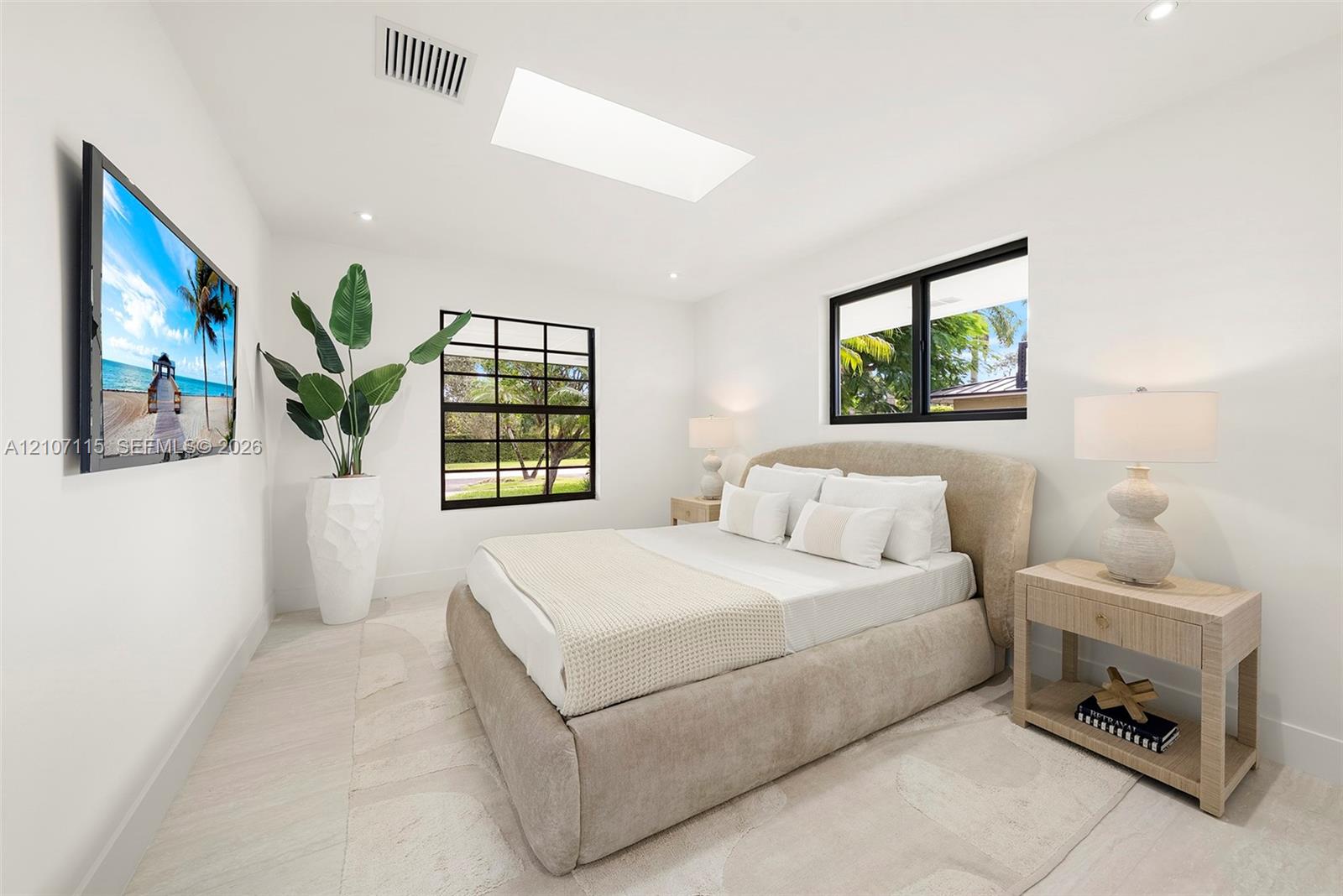 Skylight, large-format tile flooring, and multi-pane windows with black frames