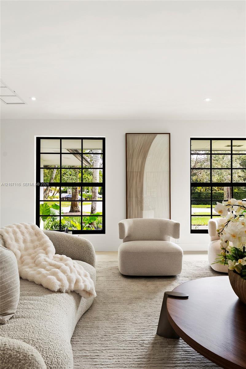 Black-framed multi-pane windows and recessed ceiling lighting